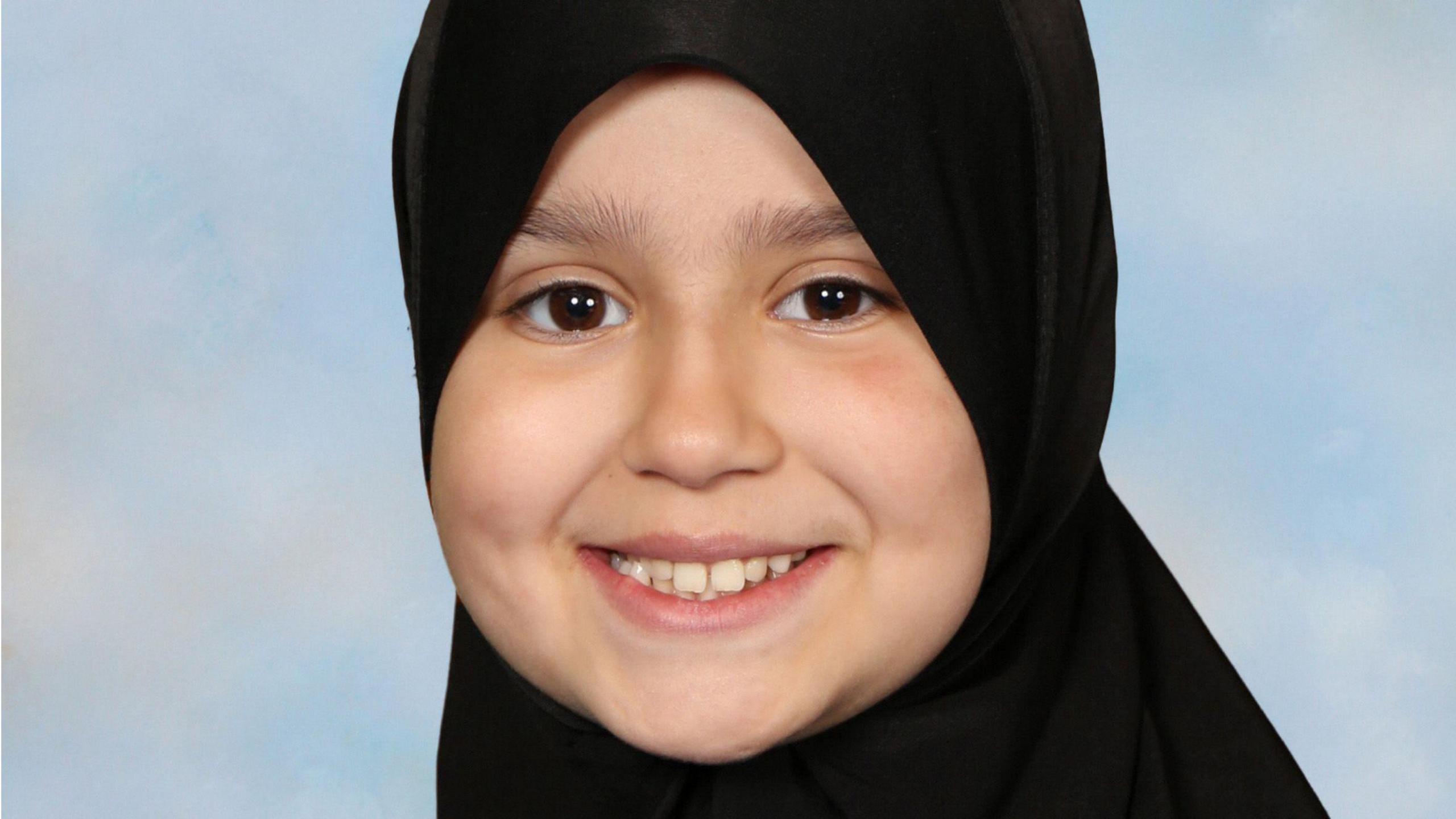 Sara Sharif wearing a hijab and smiling. She is looking directly at the camera. 