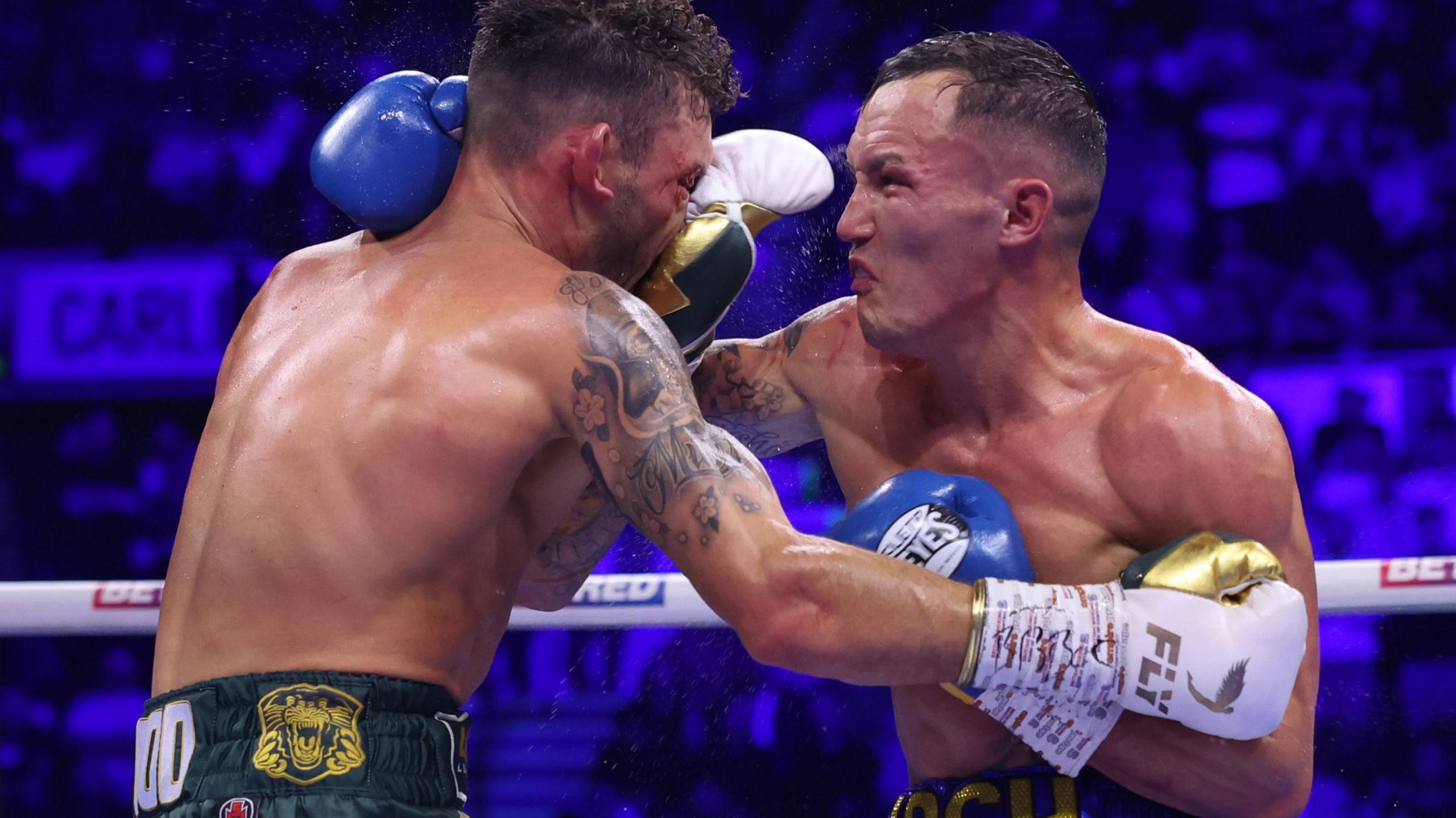 Leigh Wood (left) and Jos Warrington (right) trade blows in their October 2023 bout