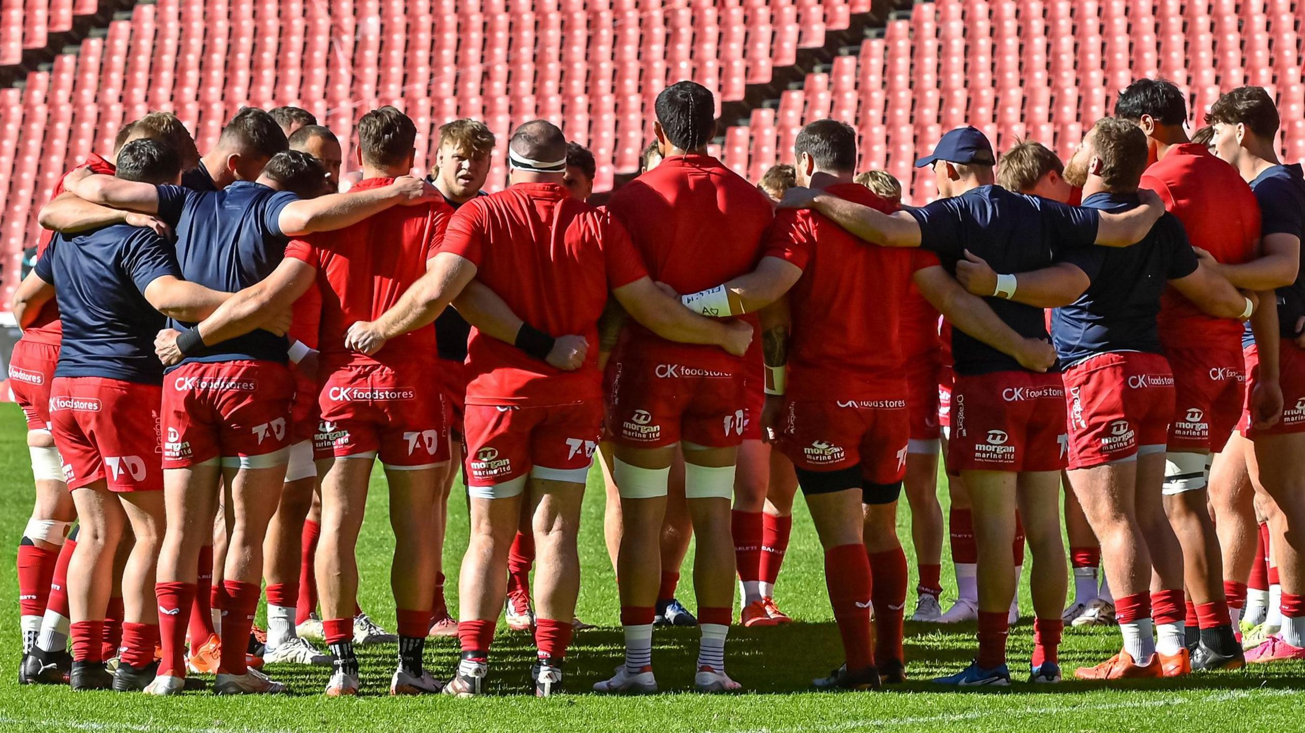 Scarlets players stand in a huddle ahead of their 32-19 win over Lions in Johannesburg.