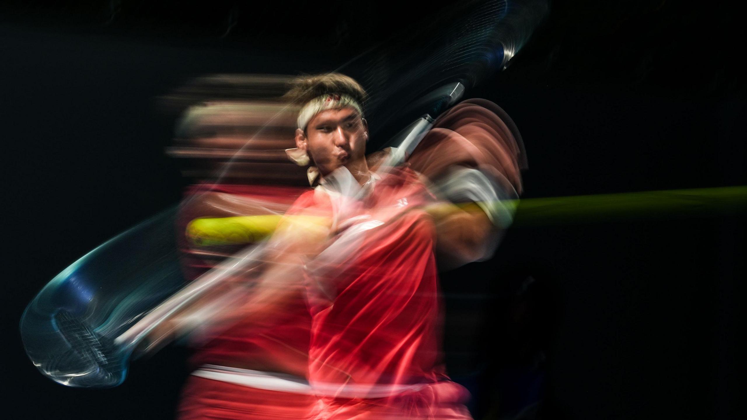 Yunchaokete Bu of China plays a forehand in the Men's Singles First Round match against Hady Habib of Lebanon during day one of the 2025 Australian Open at Melbourne Park in Melbourne, Australia