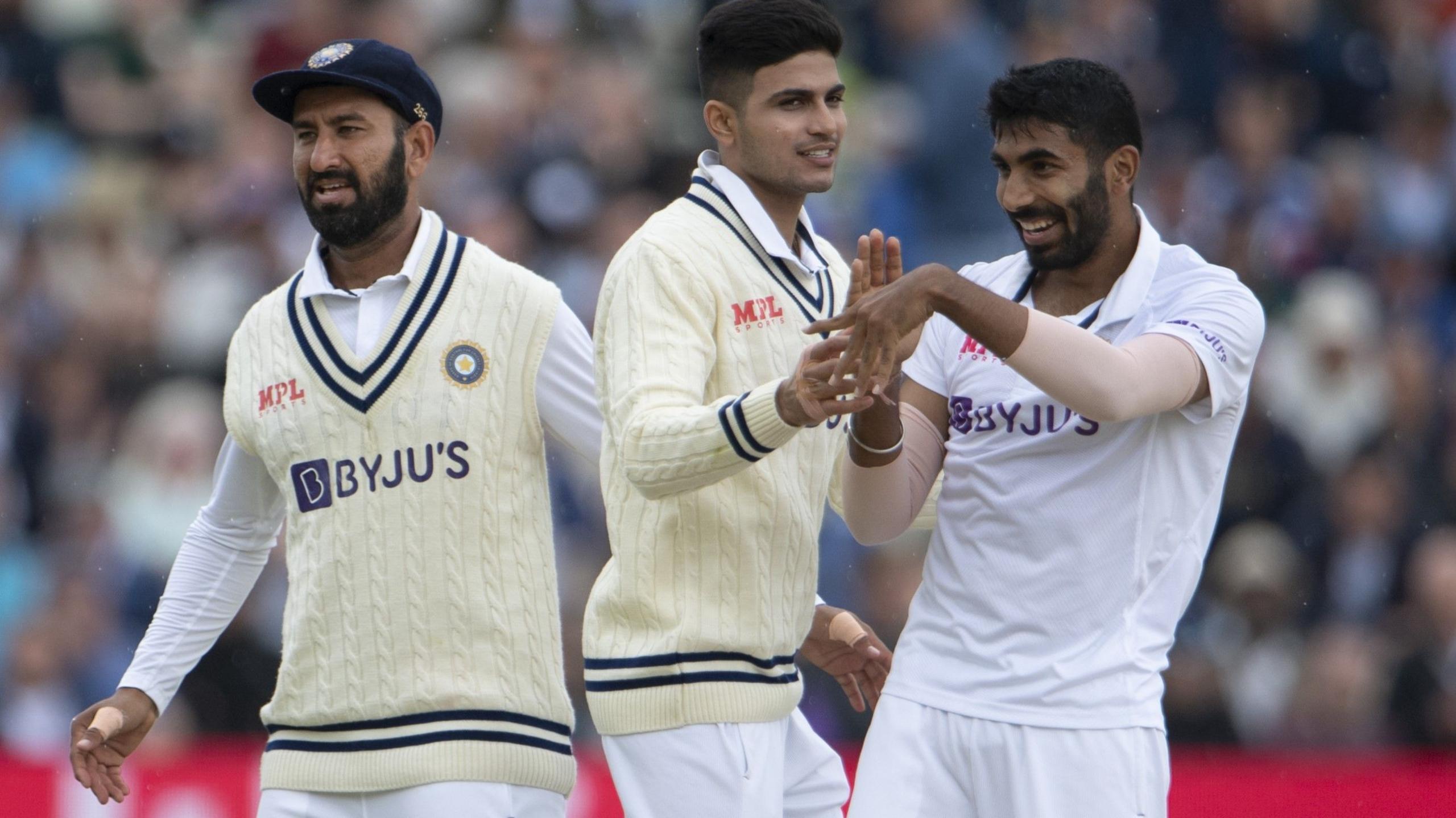India celebrate a wicket - from left, Che Pujara, Shubman Gill and Jasprit Bumrah