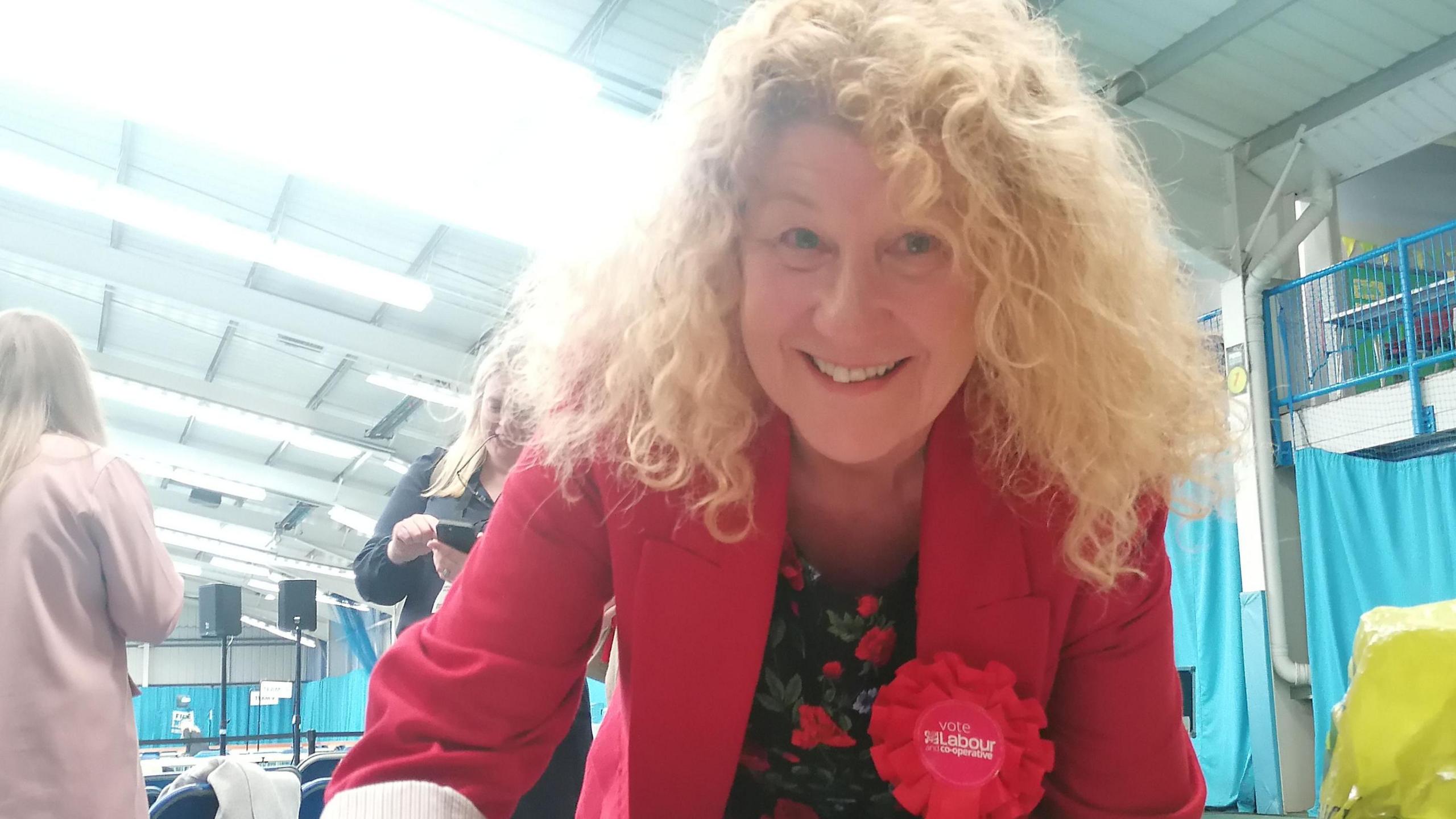 Susan Dungworth with a big red rosette smiling into the camera