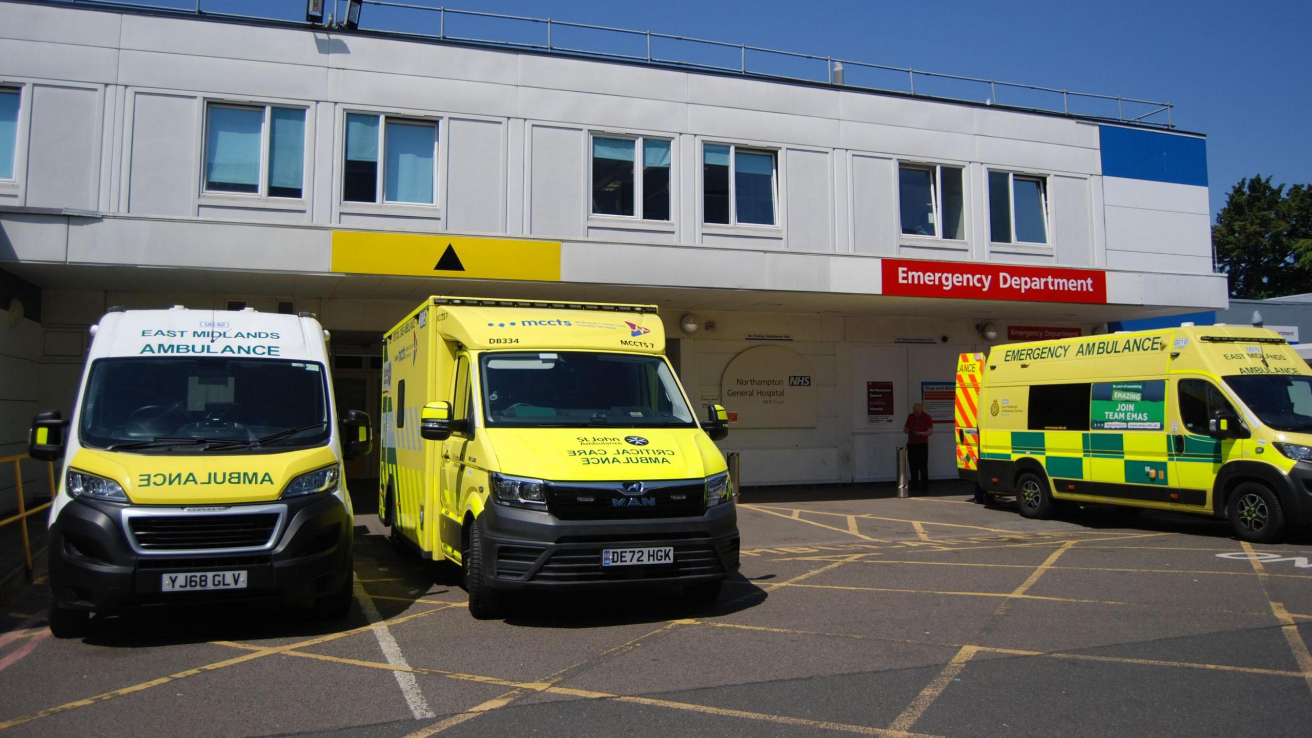 An outside view of Northampton General Hospital's A&E department which shows three ambulances parked outside near the entrance to the building. 