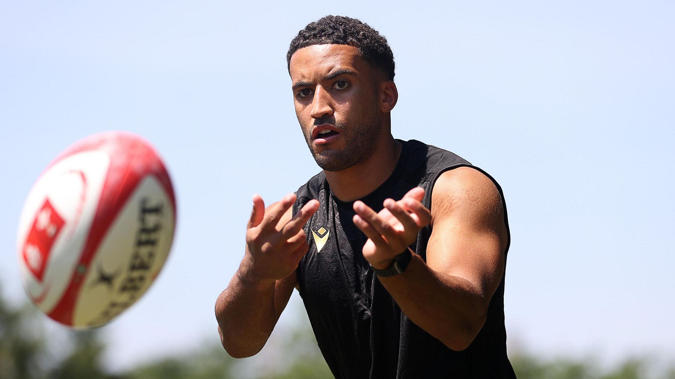 Keelan Giles passes a ball in training