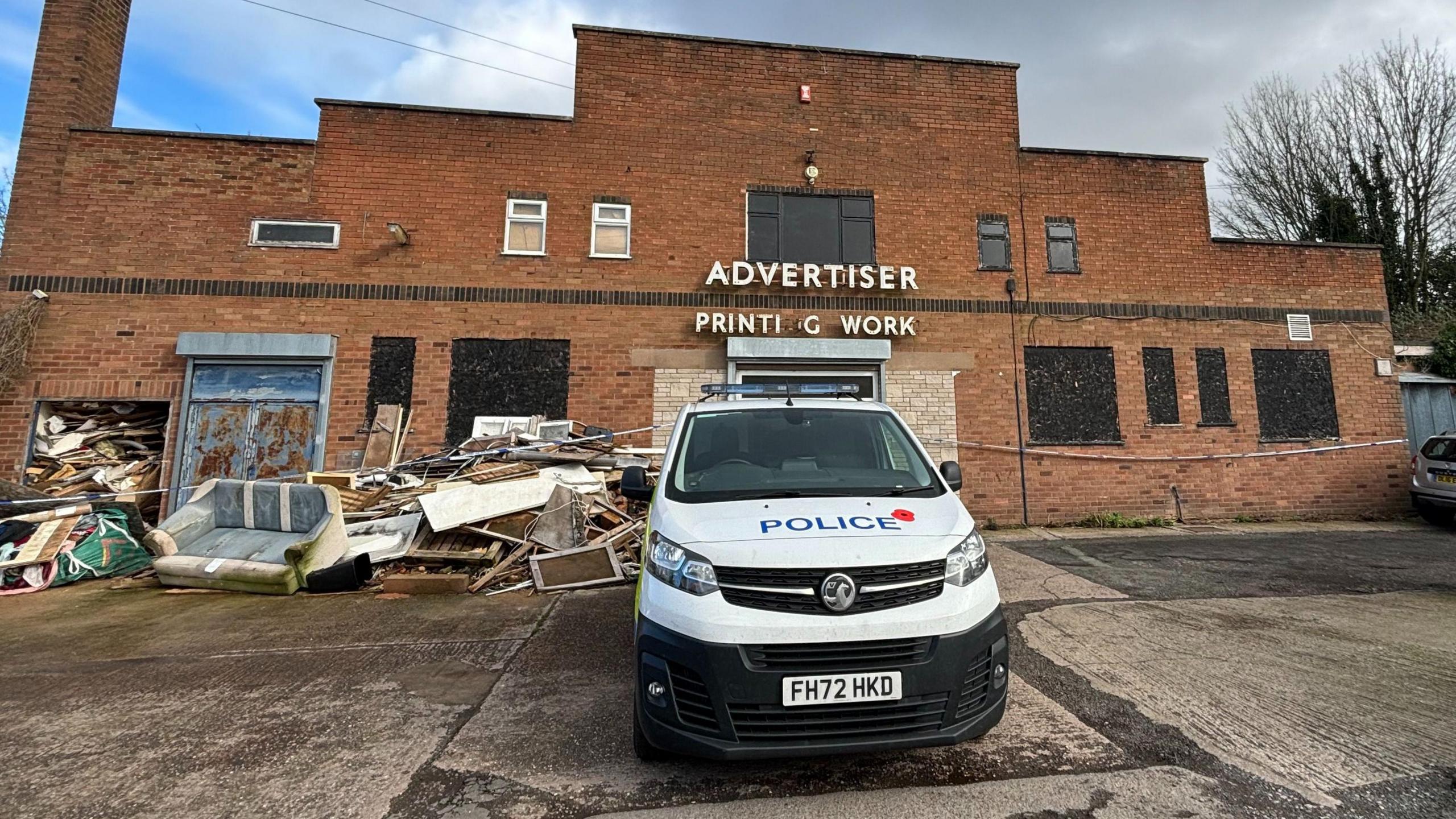 Police van outside industrial unit