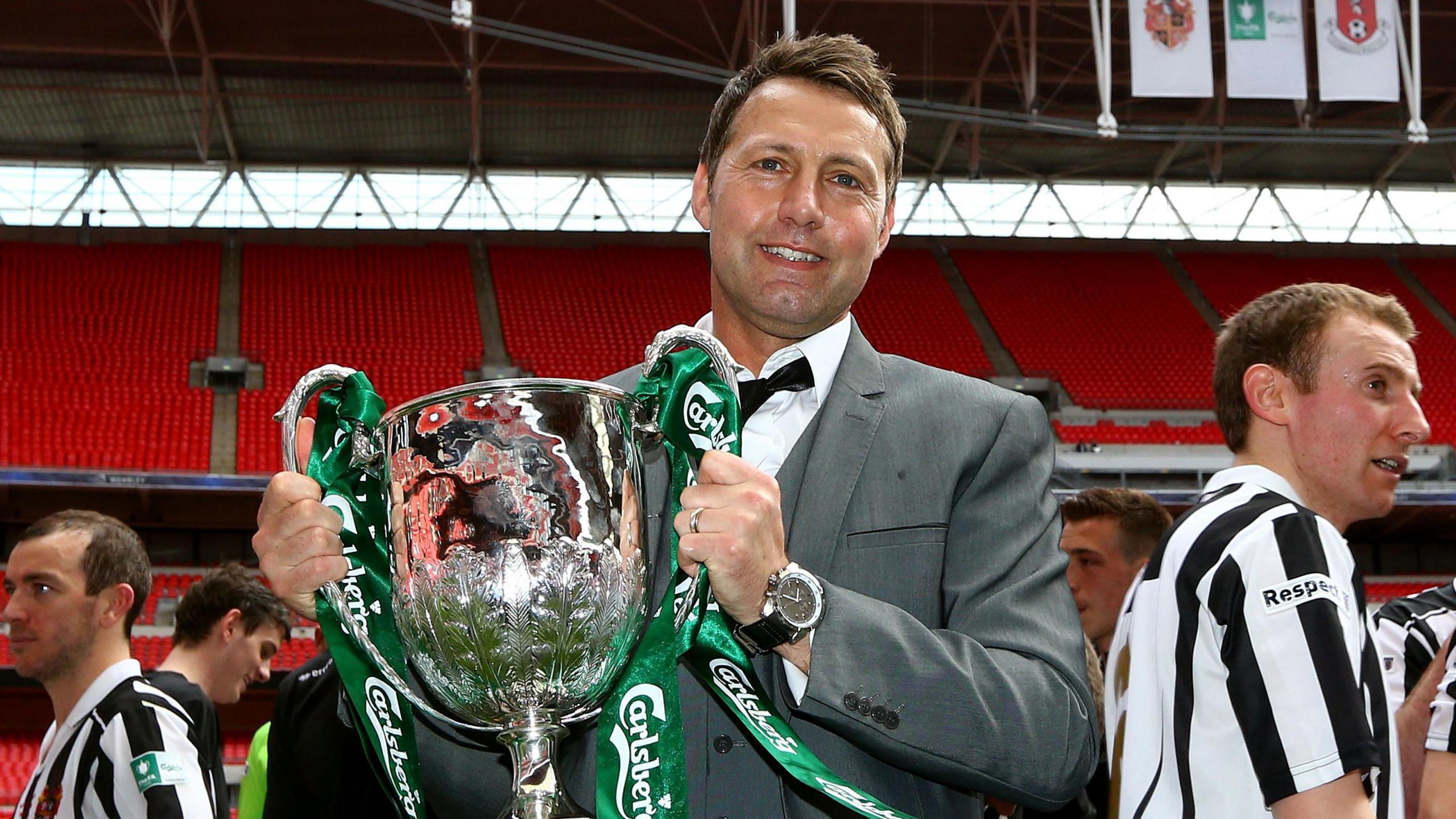 Jason Ainsley holding the FA Vase trophy at Wembley in 2013