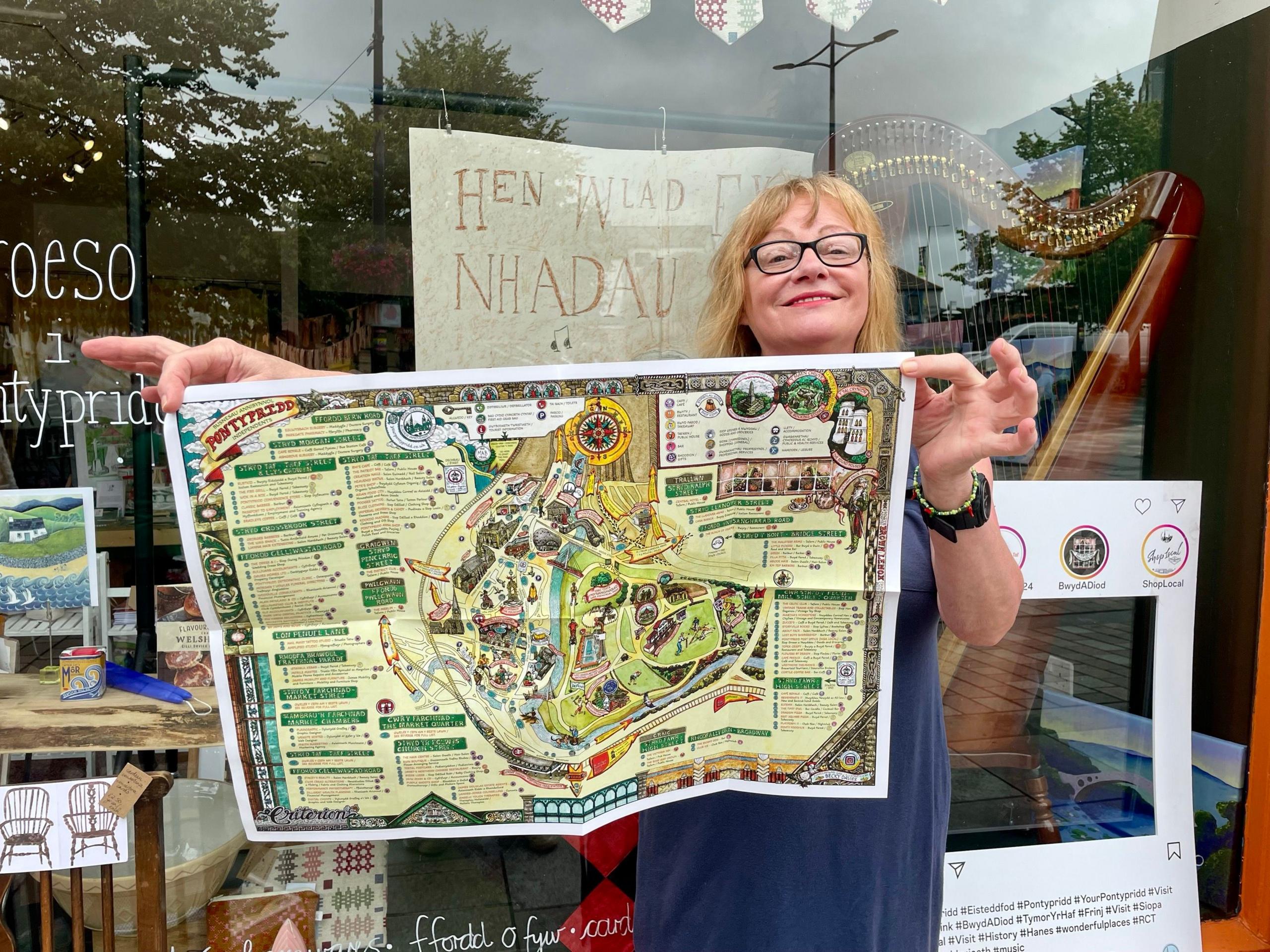 Jayne Coleman, owner of Martha’s Homestore, holding a map of independent businesses in Pontypridd