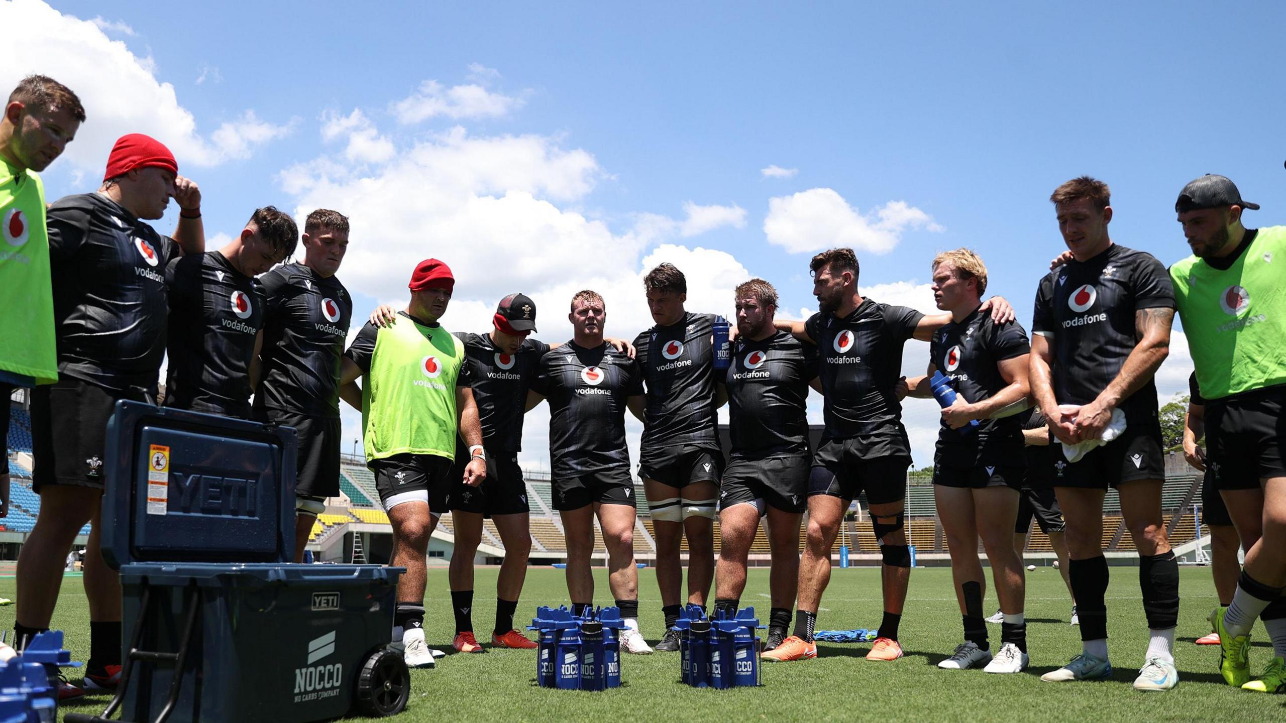 Wales players in a team huddle during training