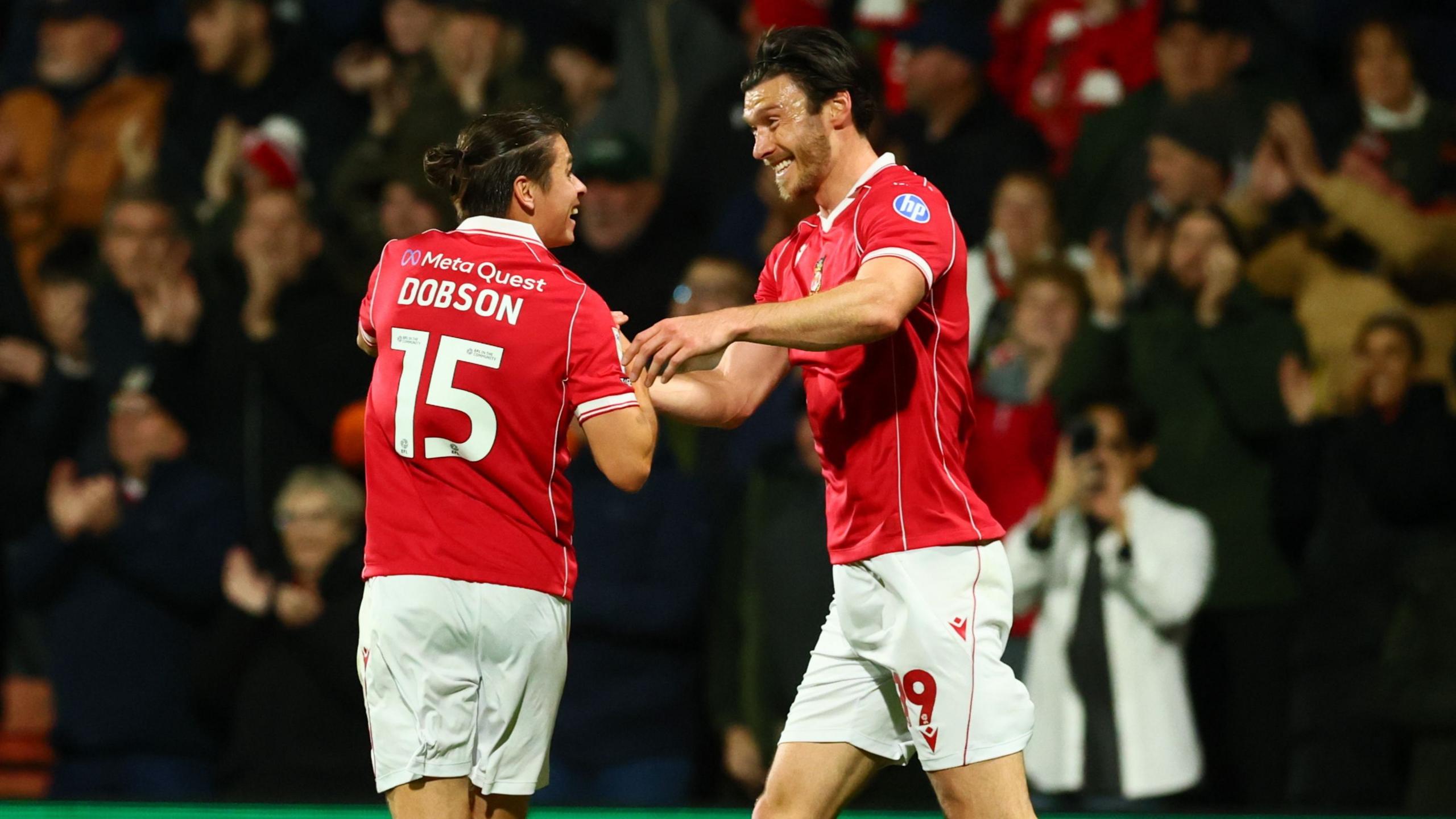 Wrexham midfielder George Dobson (L) celebrates with Kieffer Moore