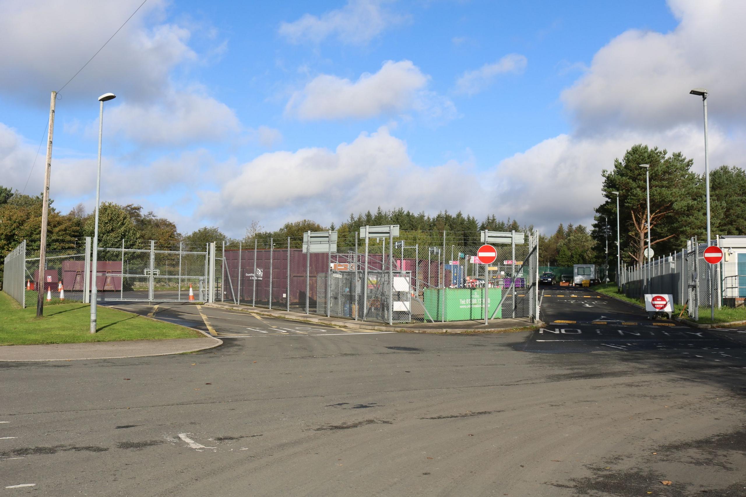 A household waste recycling centre with gates around it and no entry signs at one side