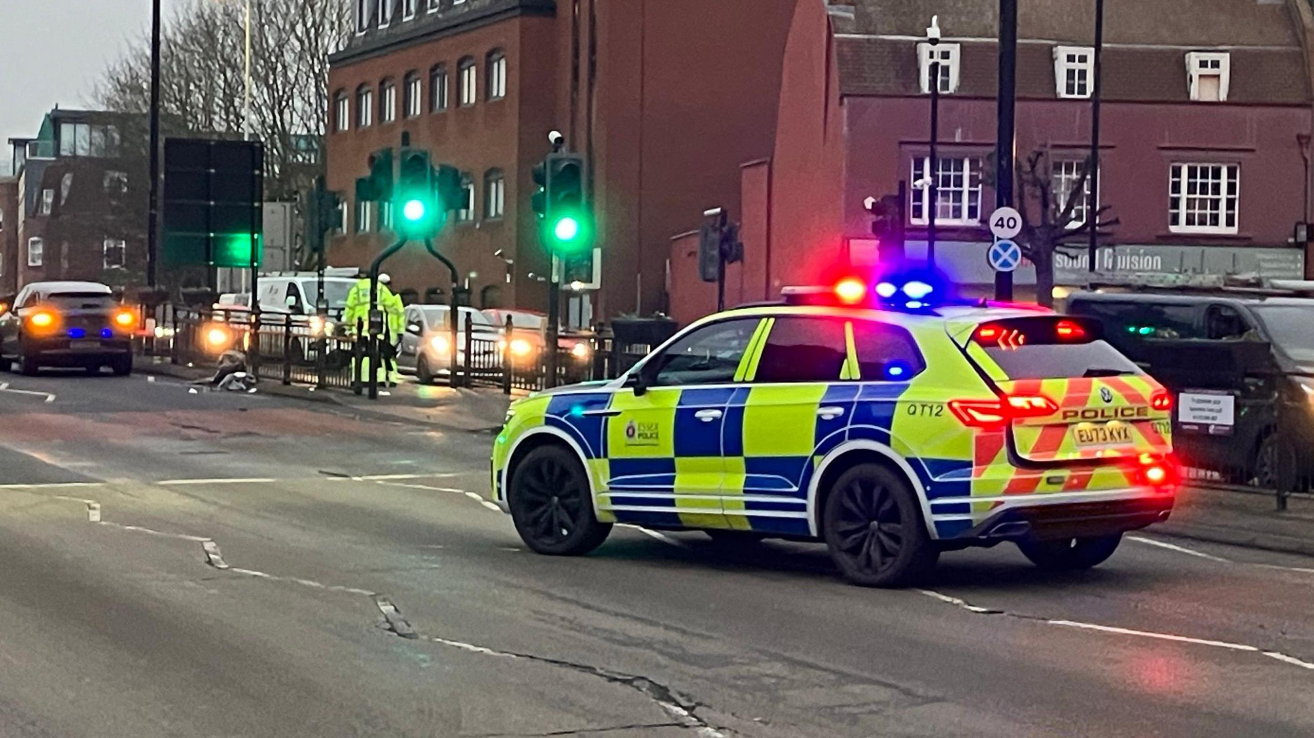 A police car is parked with its lights on on Parkway at the Moulsham St junction.