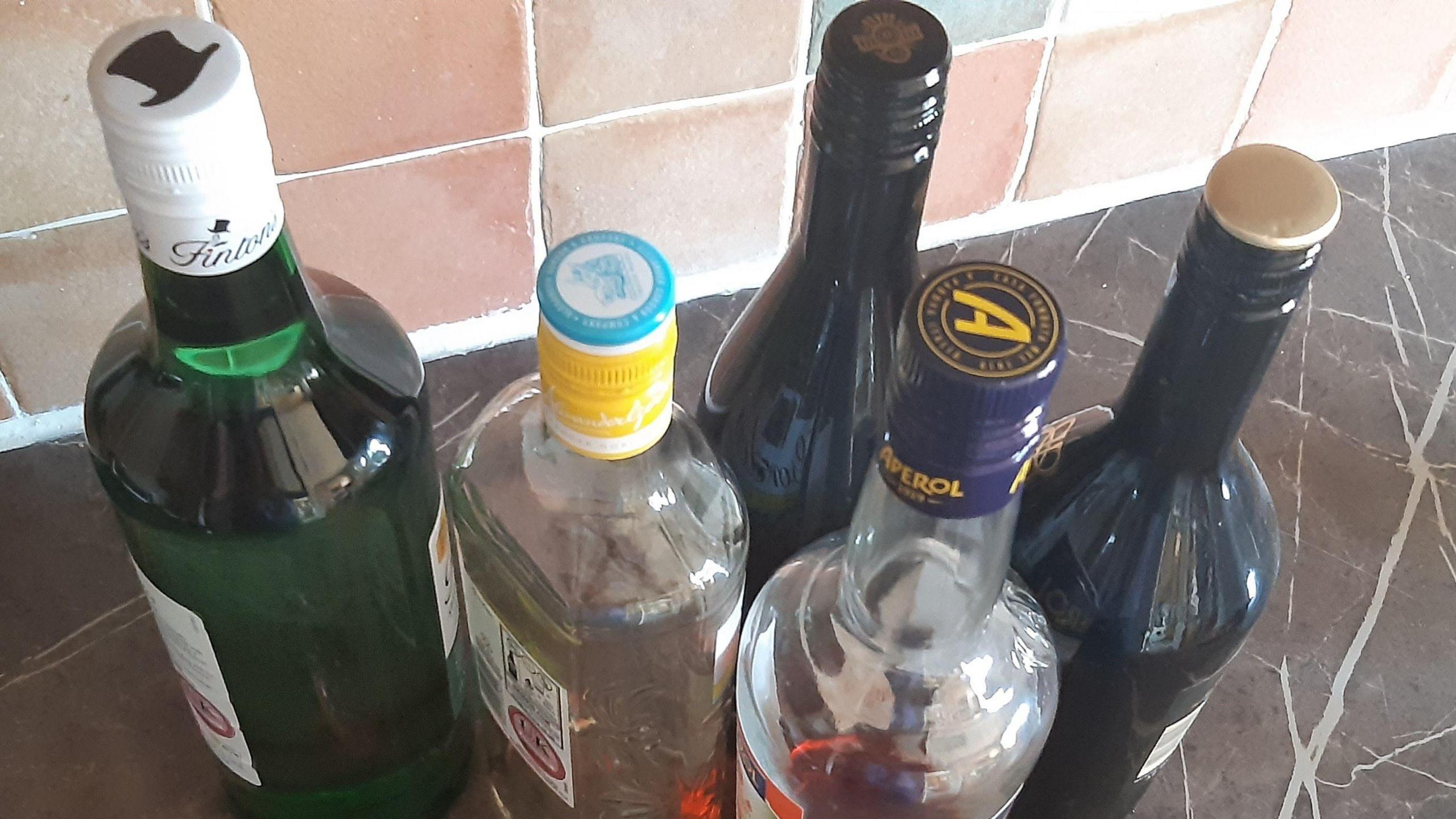 Bottles of alcohol in on a kitchen worktop