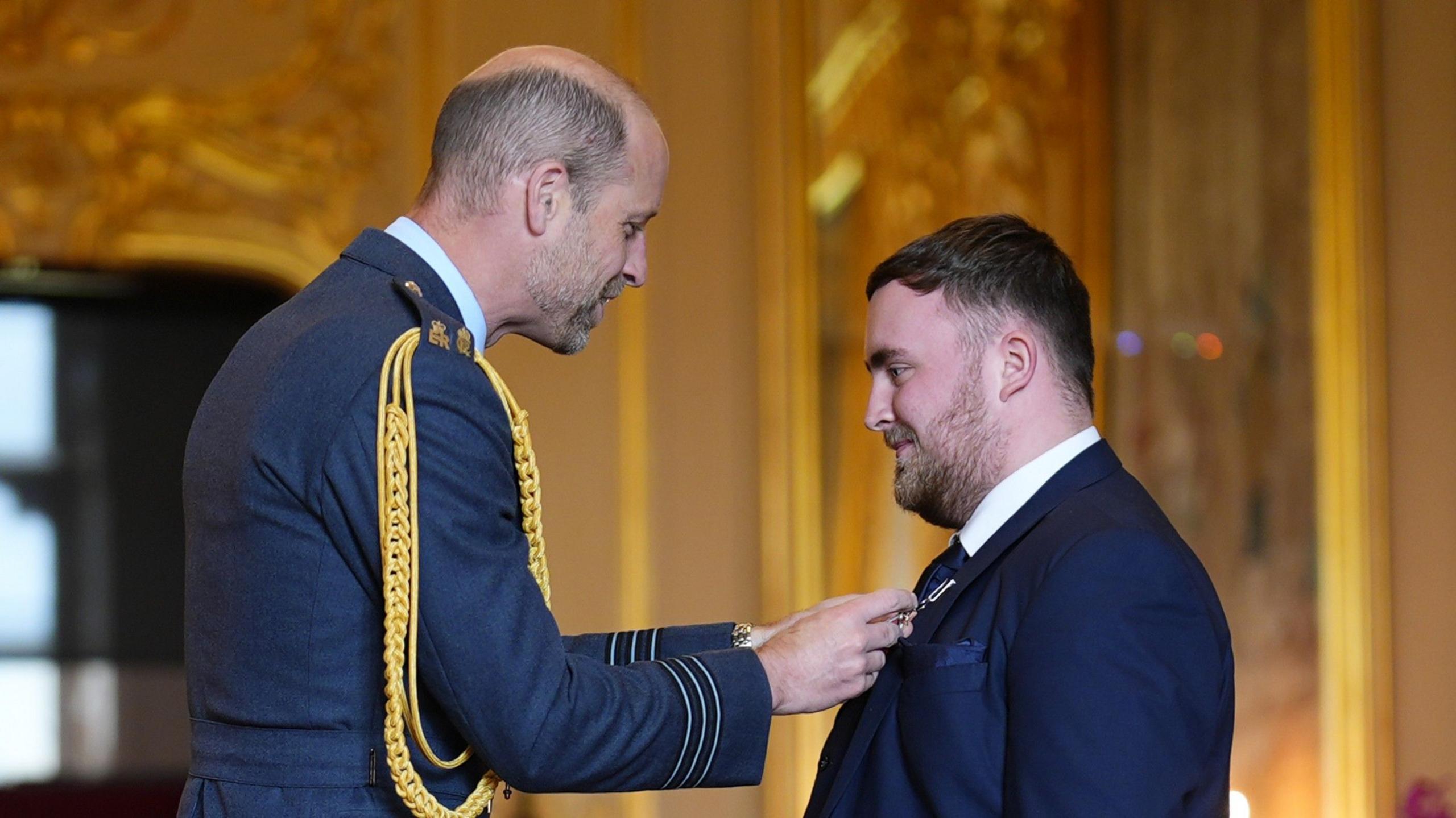 Prince of Wales presents Luke Littler with MBE