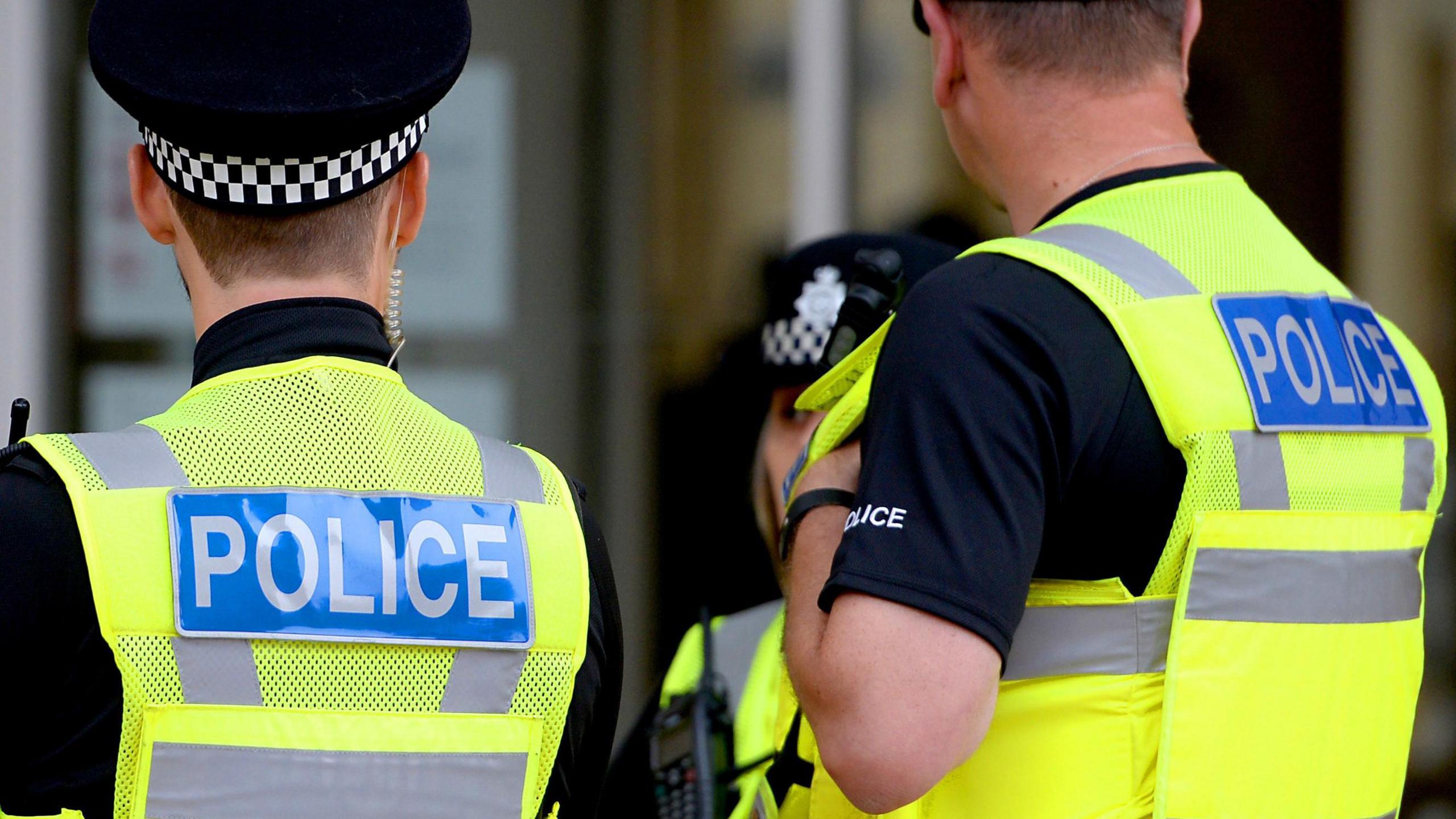 Two police officers facing away from camera