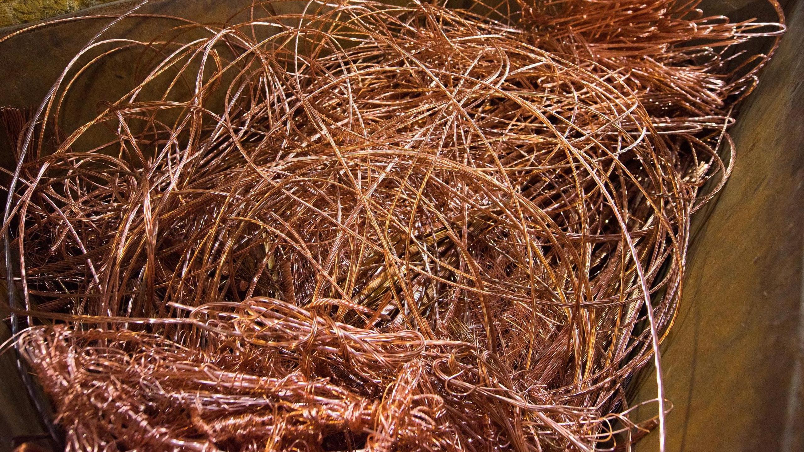 A large number of copper cables tangled up in a receptacle
