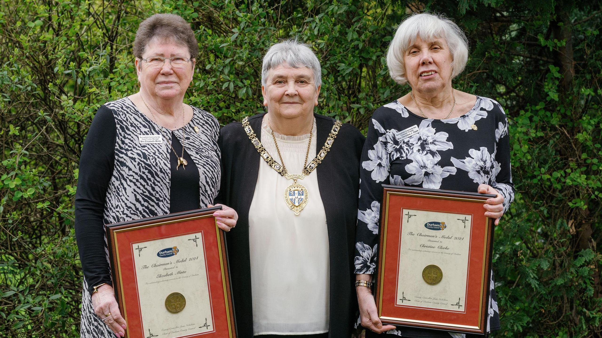 County Durham volunteers holding their Chairman's Medals with the Chairman of Durham County Council