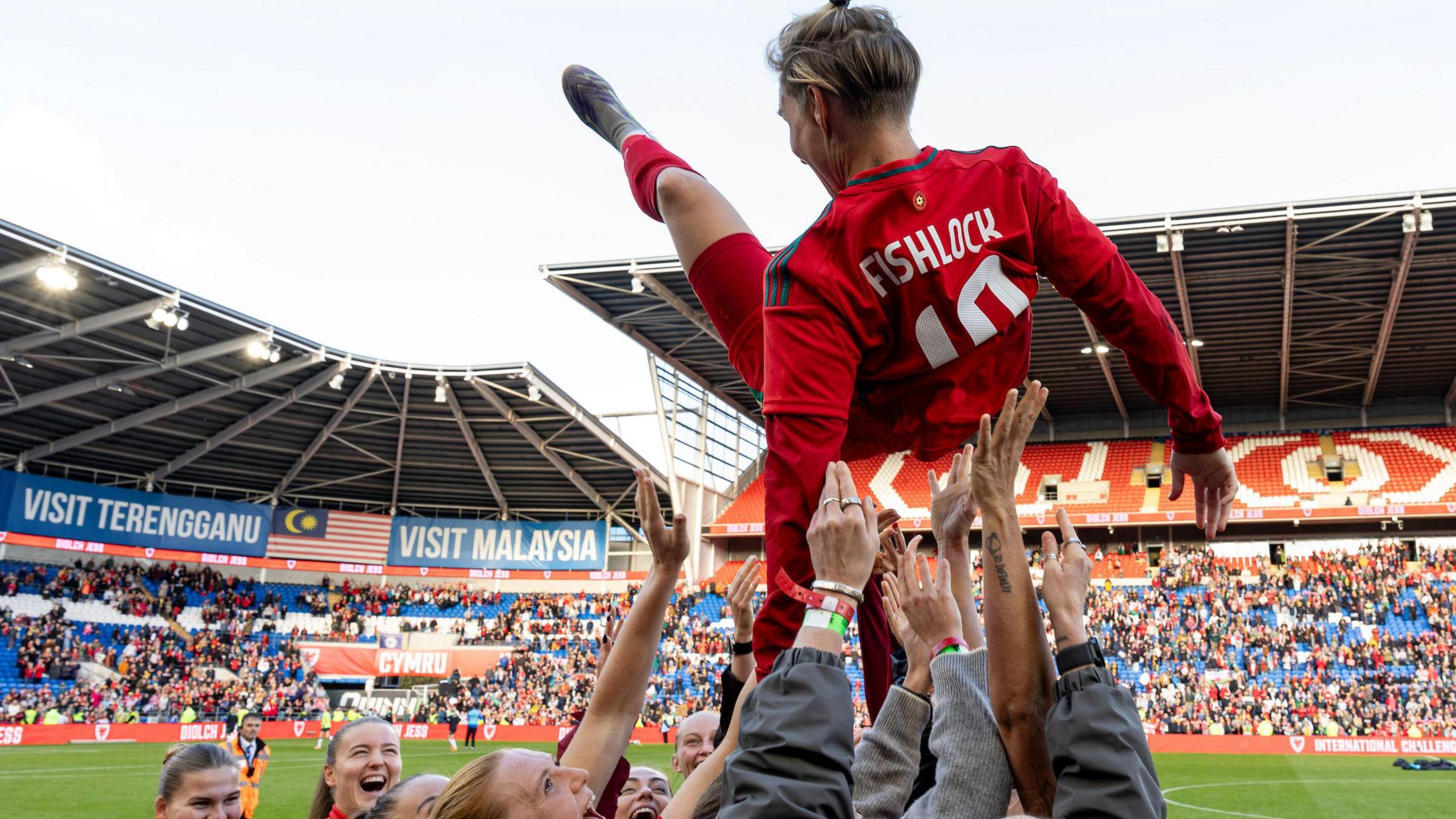 Jess Fishlock is thrown in the air by her Wales colleagues