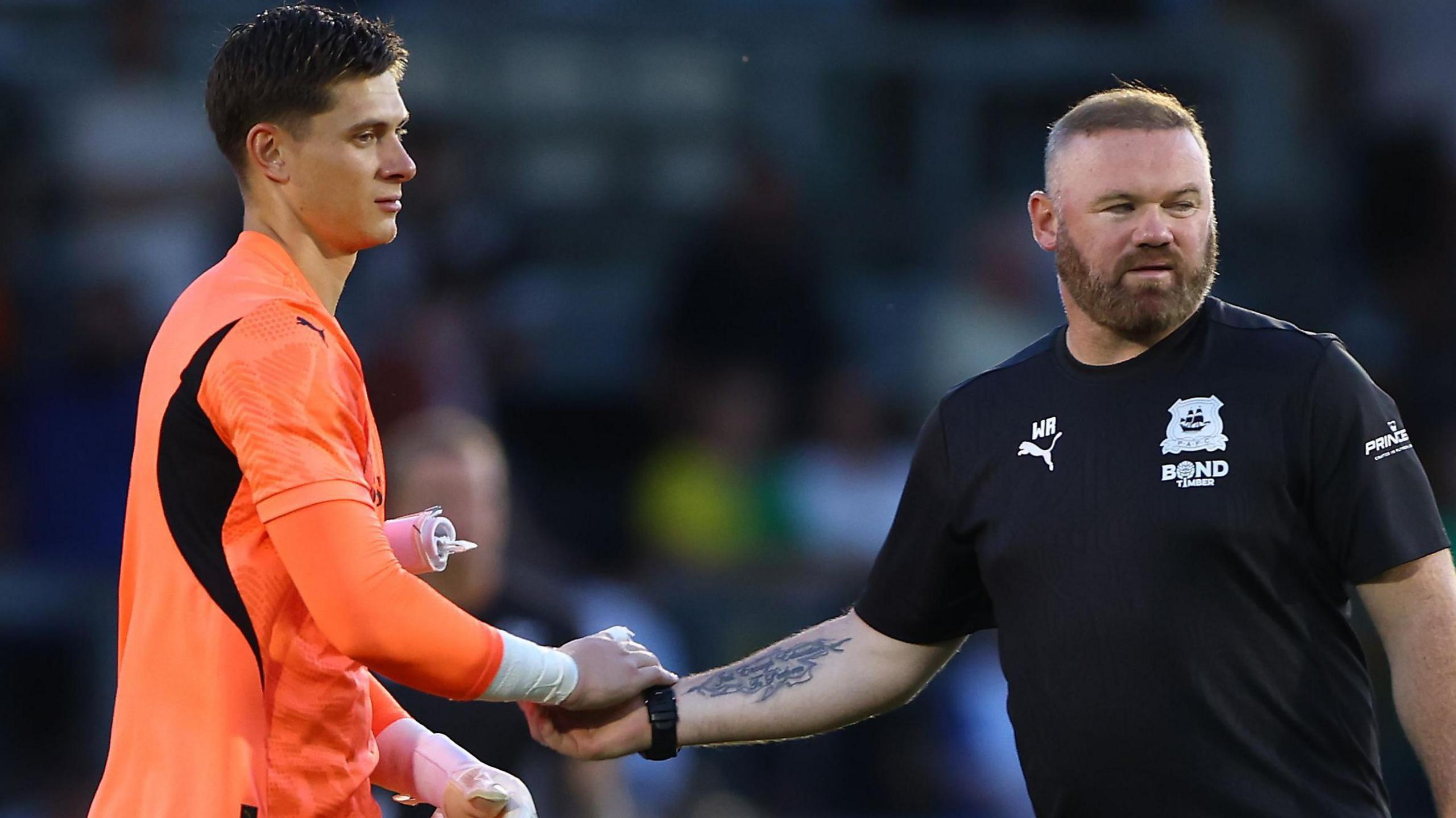 Michael Cooper shakes Wayne Rooney's hand