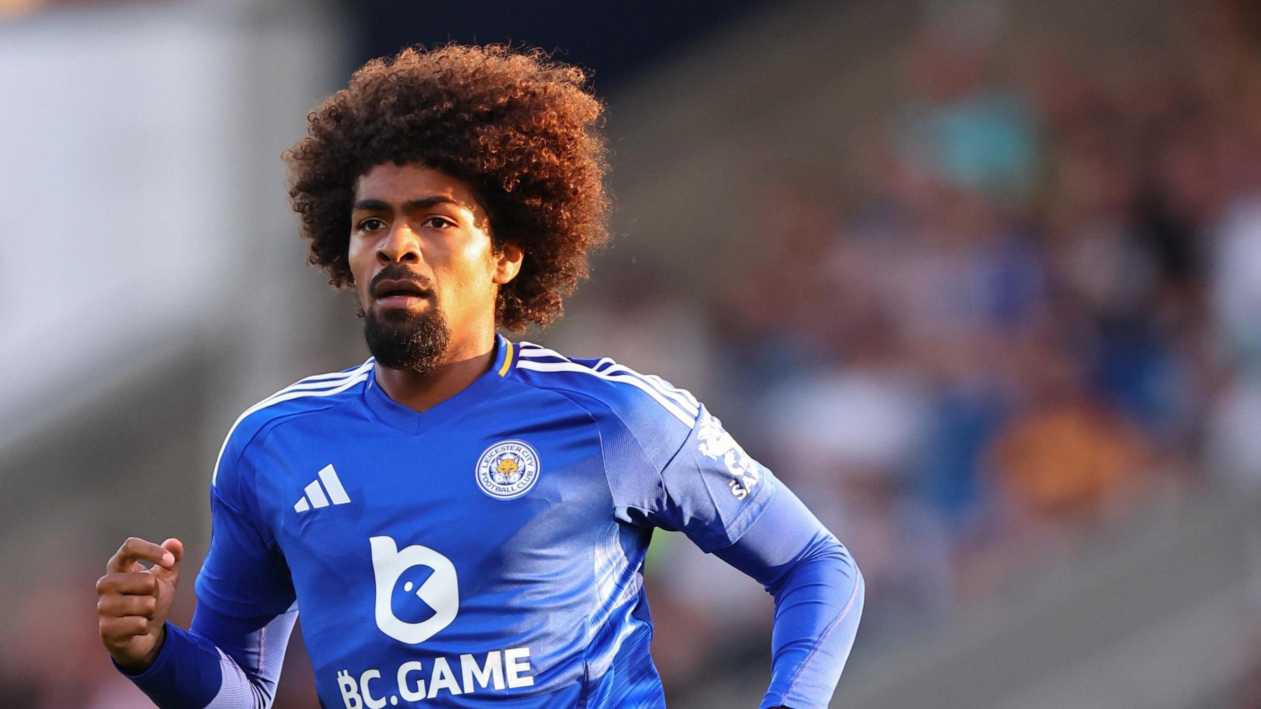 Hamza Choudhury, who is running while wearing a Leicester shirt, suffered a dislocated shoulder in training with Leicester.