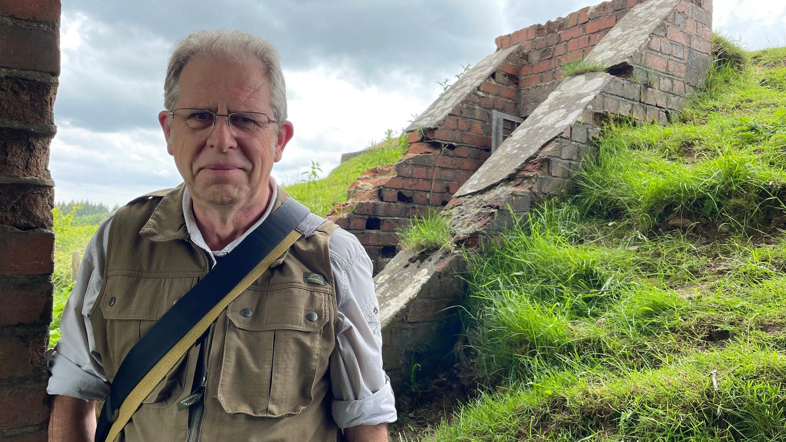 Photo of Mike Harvey in front of the Starfish bunker