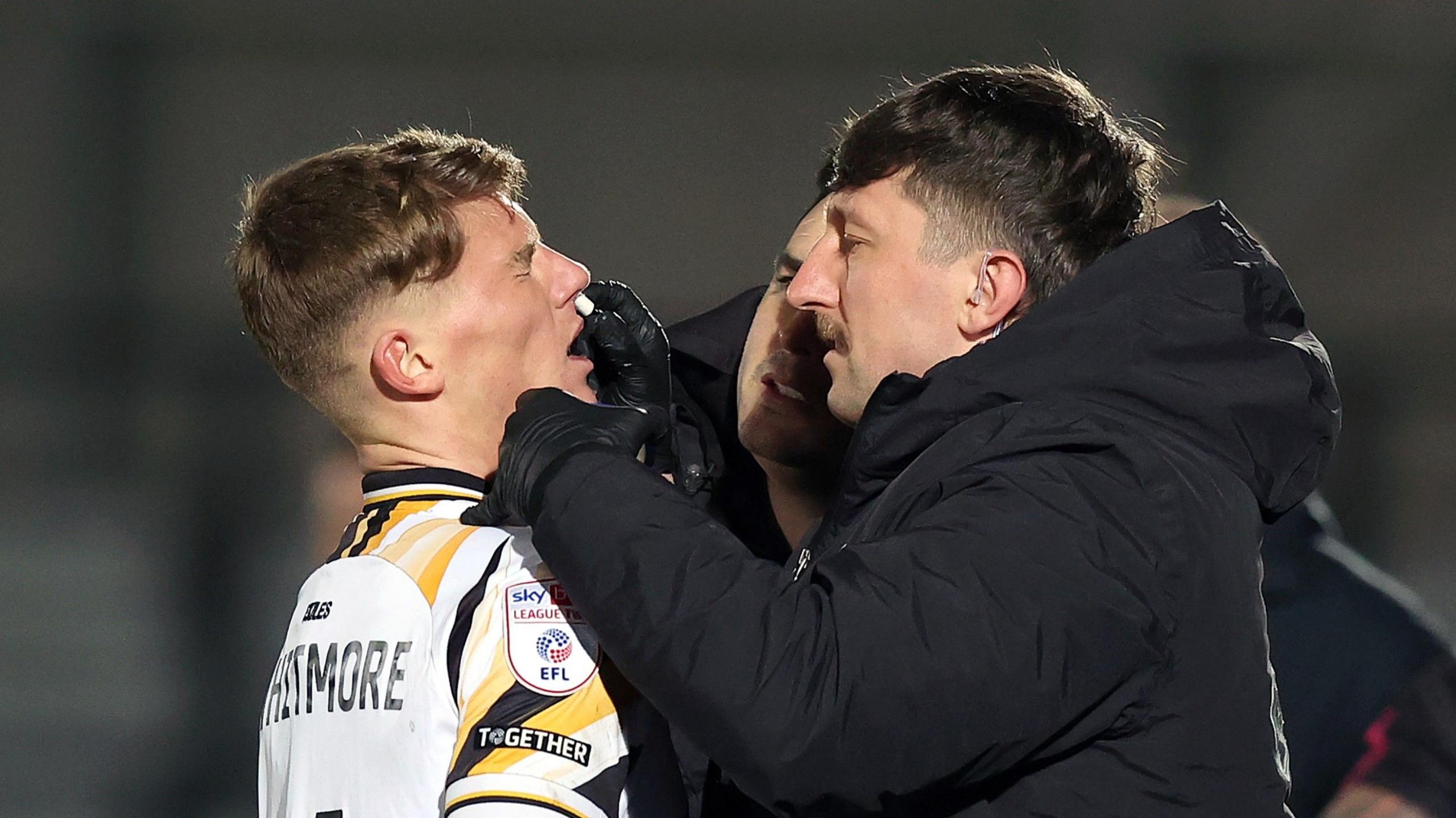 Newport County's Kai Whitmore receives treatment