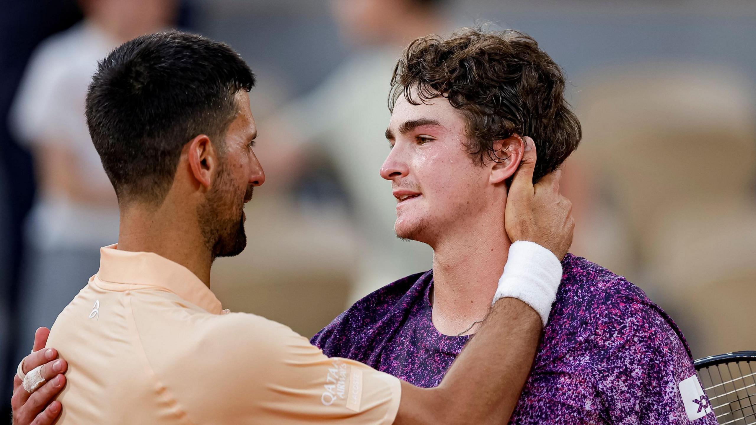 Novak Djokovic and Joao Fonseca share a warm embrace after their French Open match
