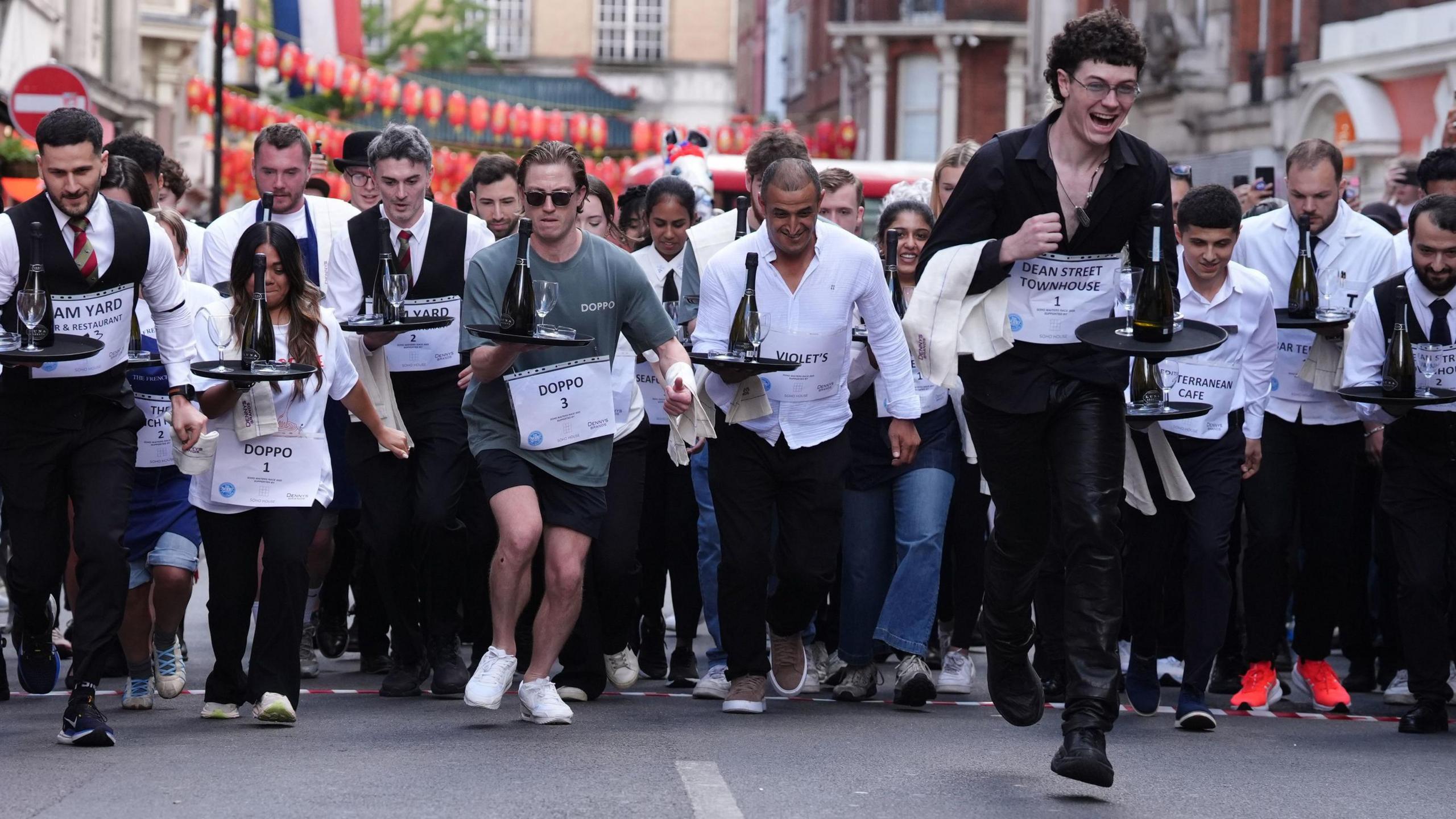 People participate in the Soho Waiter's Race at the 50th Soho Village Fete in central London. Soho's waiters, hospitality and bar staff race their way through the streets of Soho in a bid to win a trophy and £100 cash prize. Picture date: Sunday July 20, 2025.