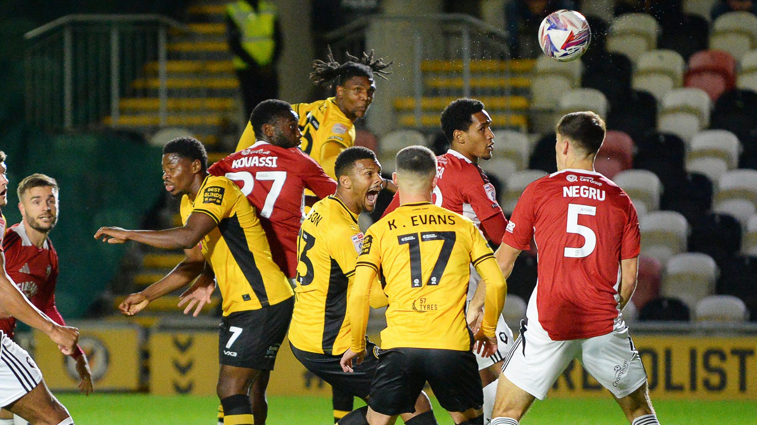 Kyle Hudlin heads in Newport's opening goal against Salford City.