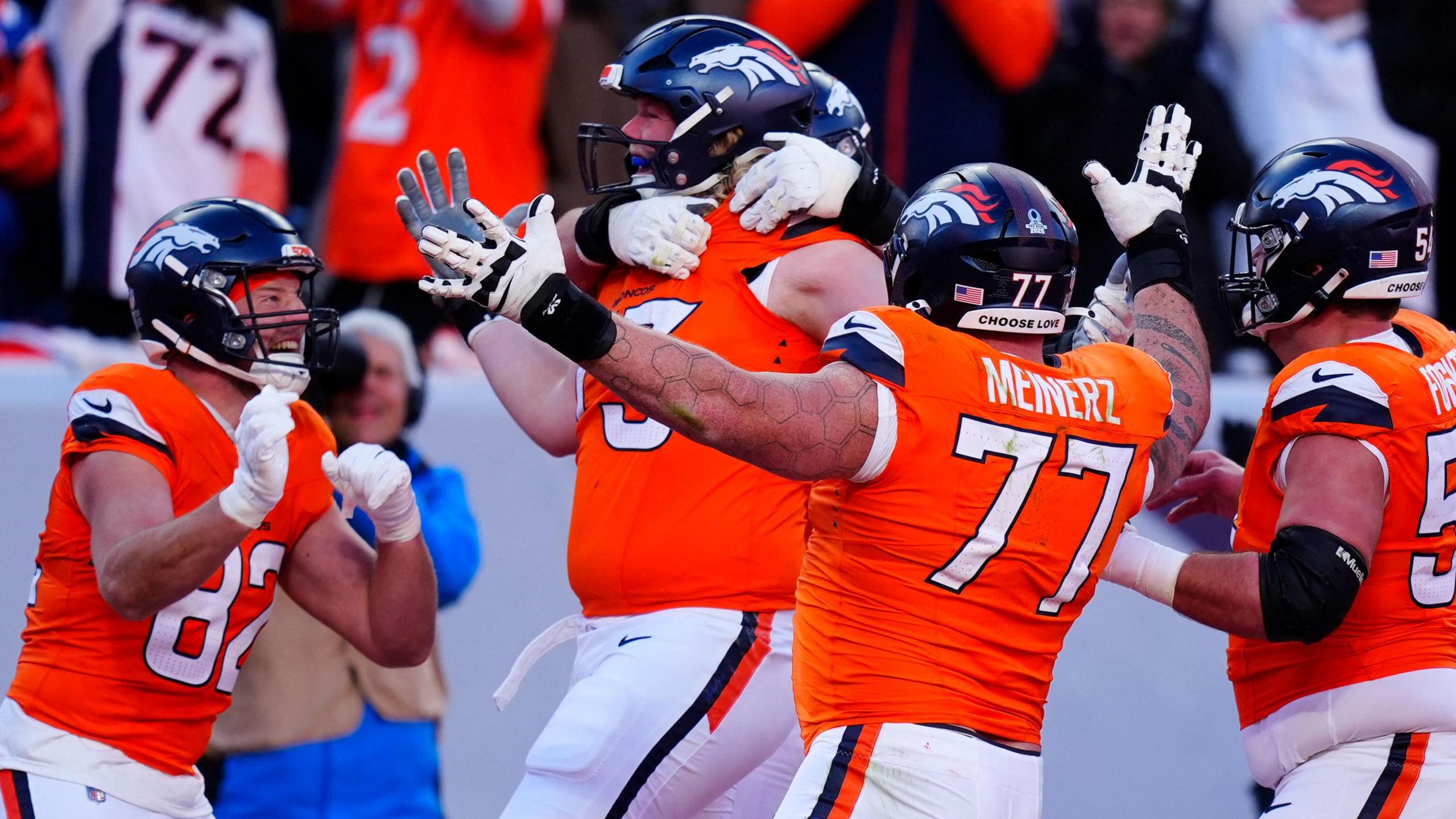 Frank Crum, offensive tackle for the Denver Broncos, rejoices with his teammates after scoring a touchdown against the Buffalo Bills