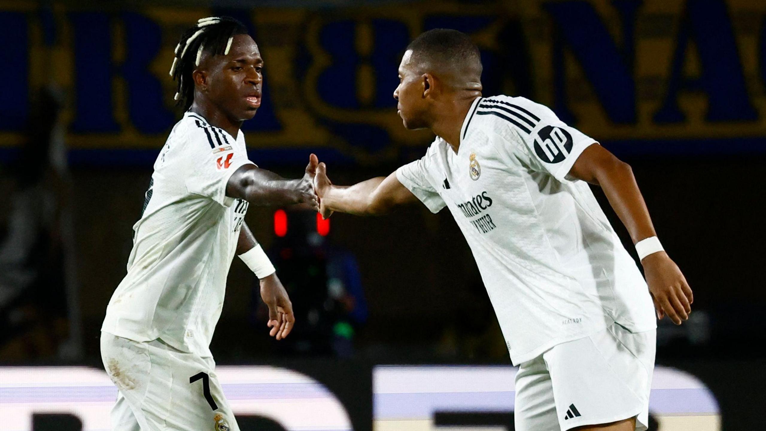 Vinicius Jr and Kylian Mbappe celebrate