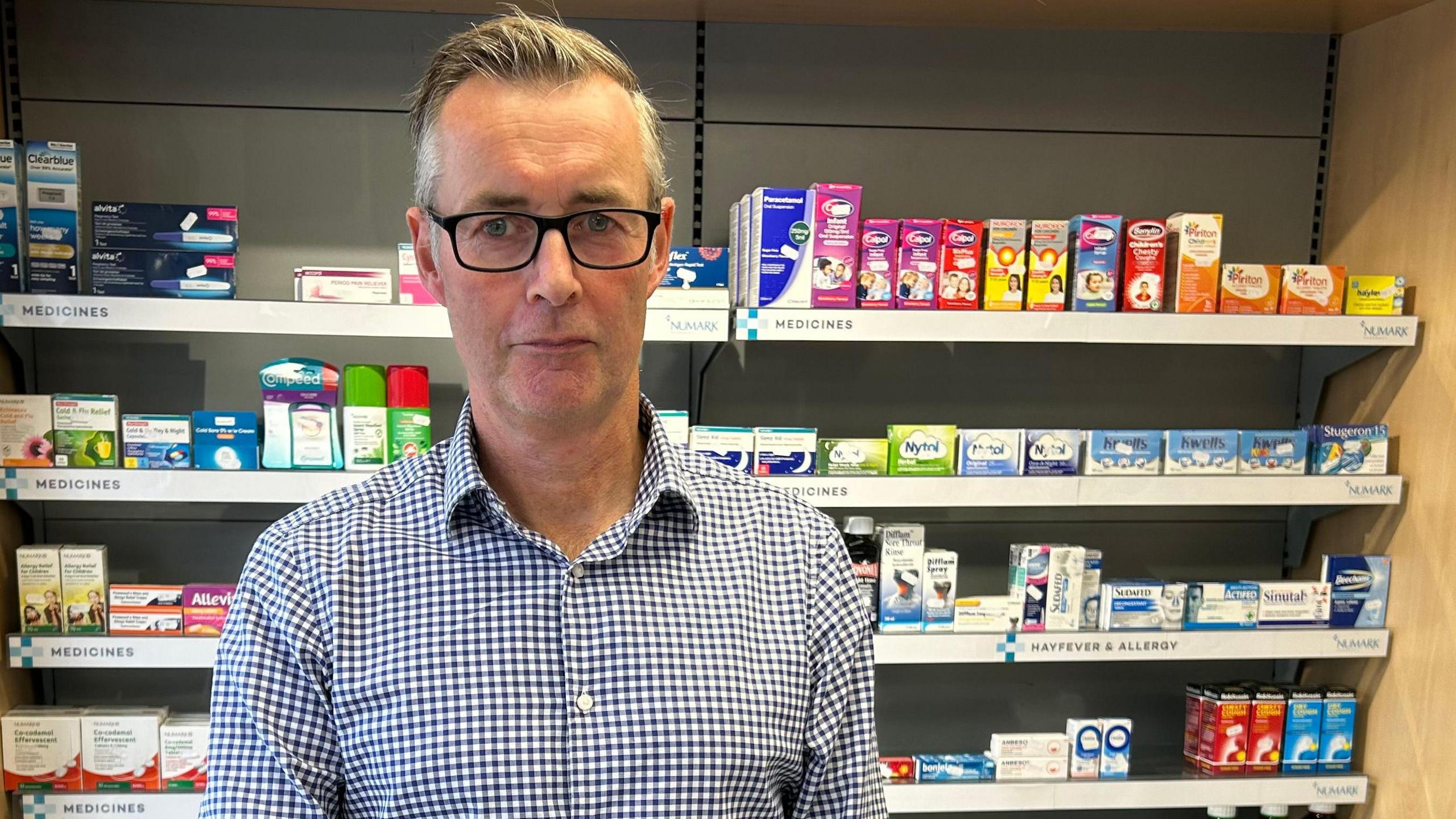 Pharmacist David Thomas, standing in his pharmacy in Newport