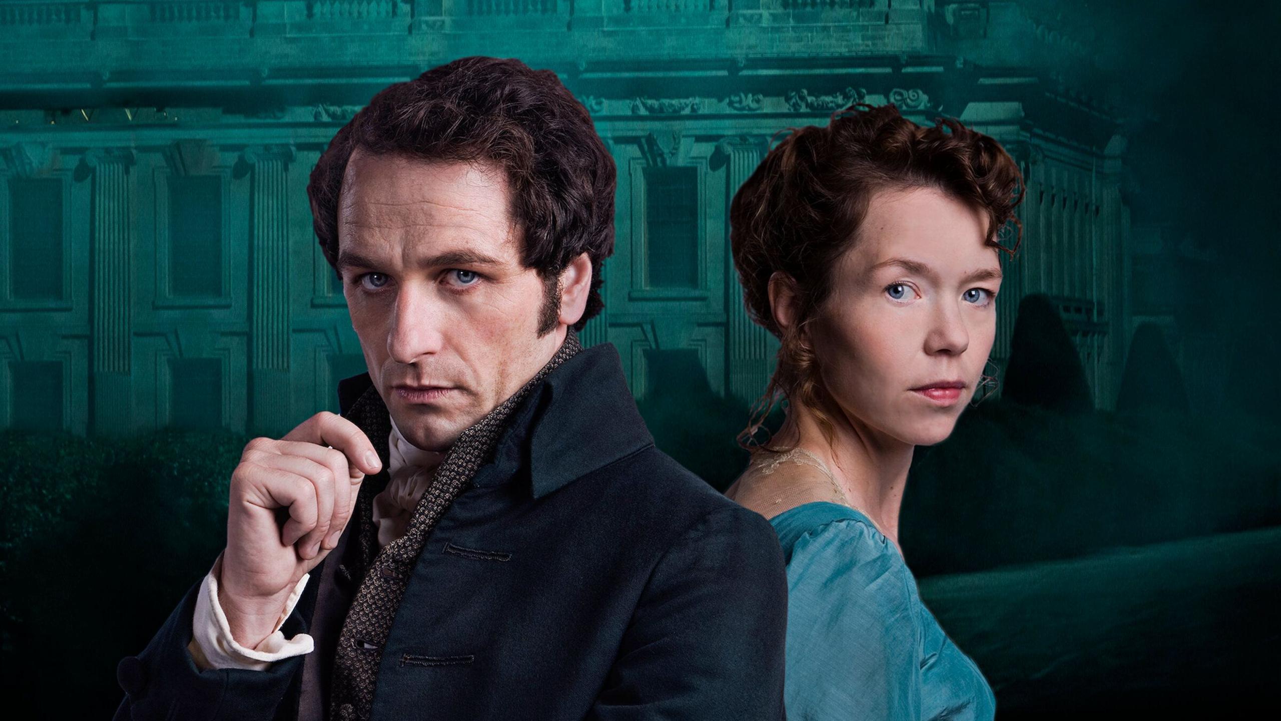 a promotional image of matthew rhys and anna maxwell martin in death comes to pemberley. matthew rhys wears a navy jacet and holds up his hand. anna maxwell martin stands behind him in a blue dress