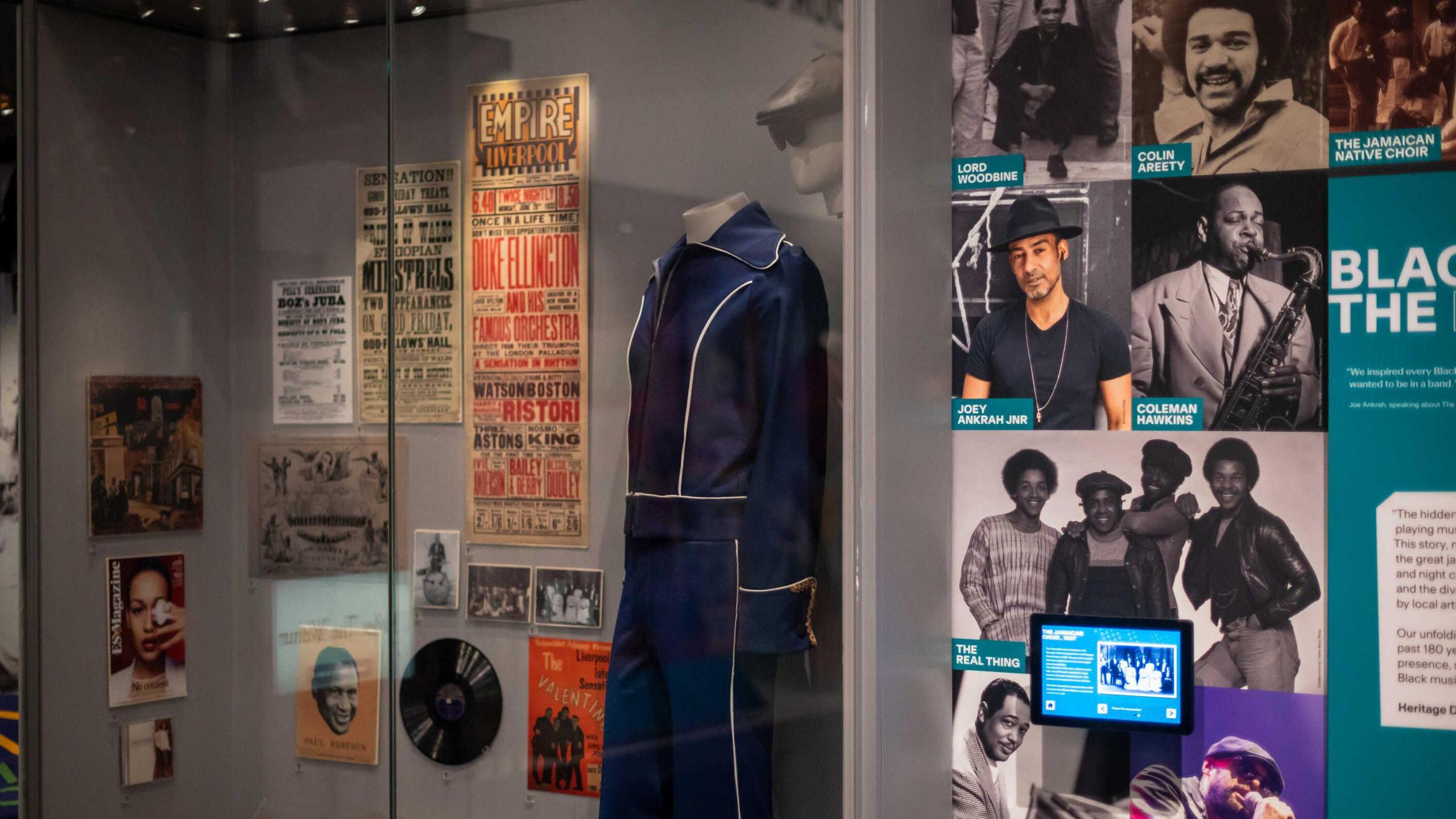 The Wondrous Place section of the exhibition showing memorabilia on display of stage outfits old records and covers with images of artists such as The Real Thing  