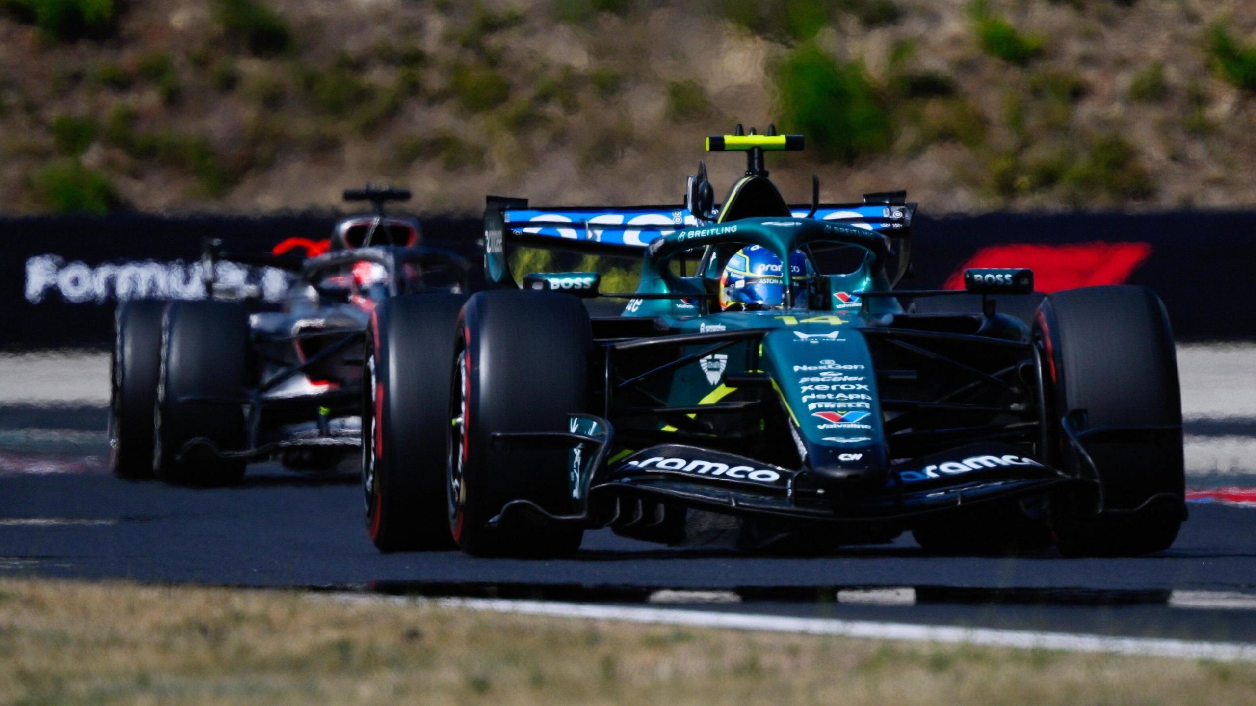 Aston Martin's Fernando Alonso with an Audi behind him during the Hungarian Grand Prix