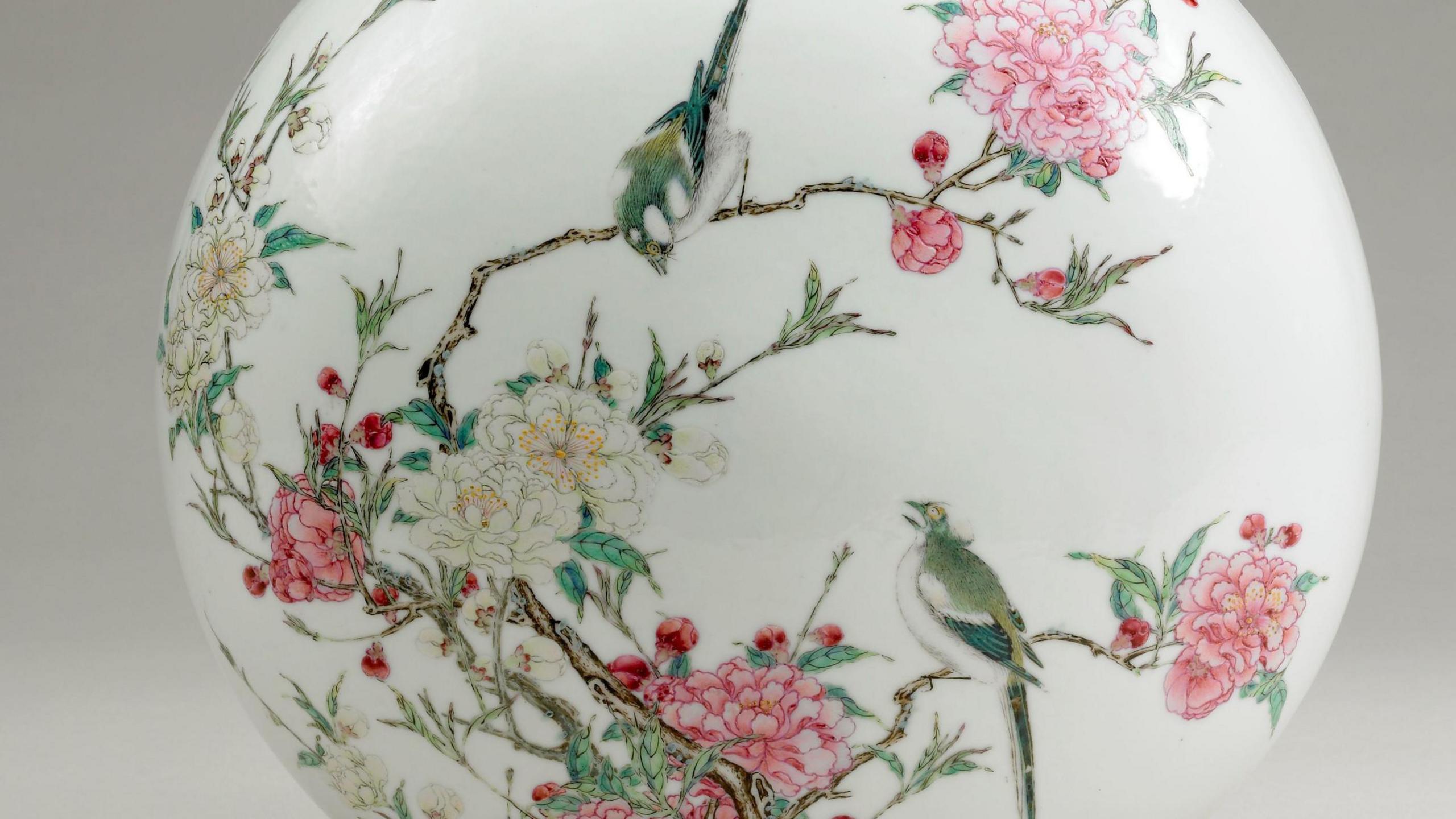 Paintings of birds and flowers on a ceramic object