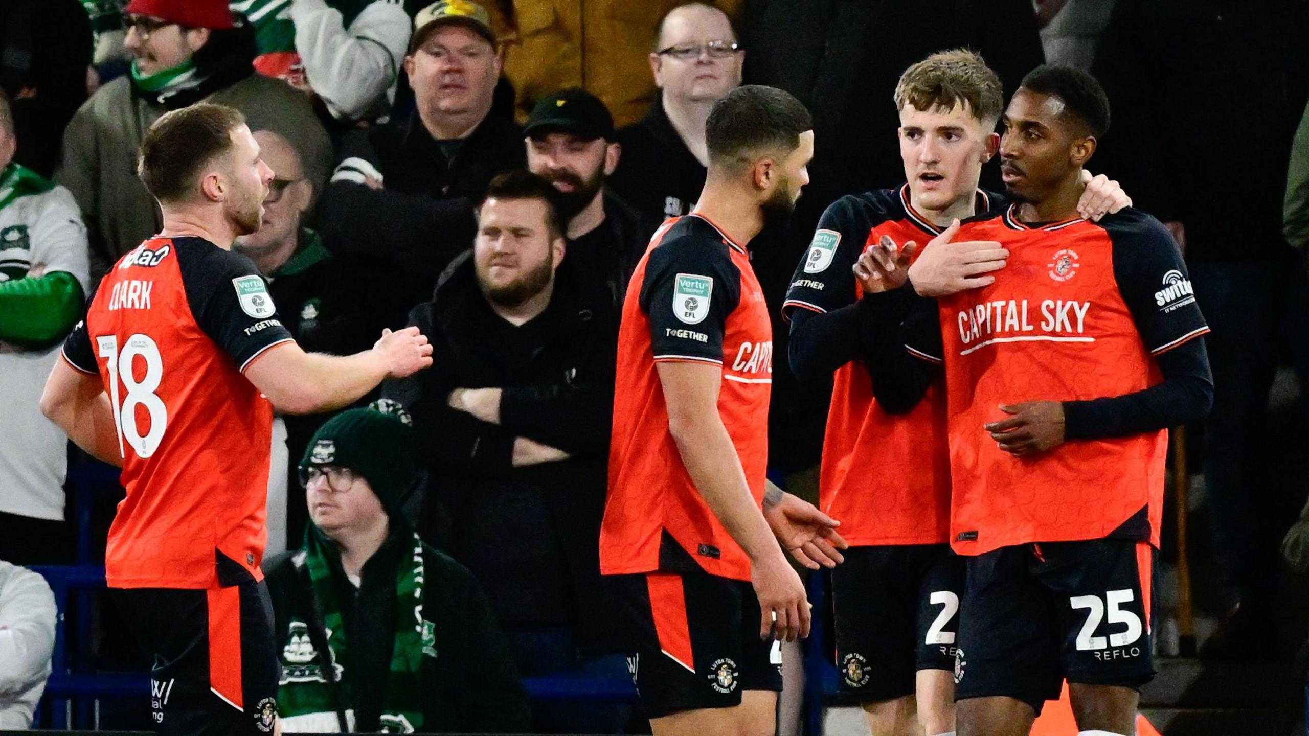 Isaiah Jones is hugged by Luton team-mates after scoring against Plymouth