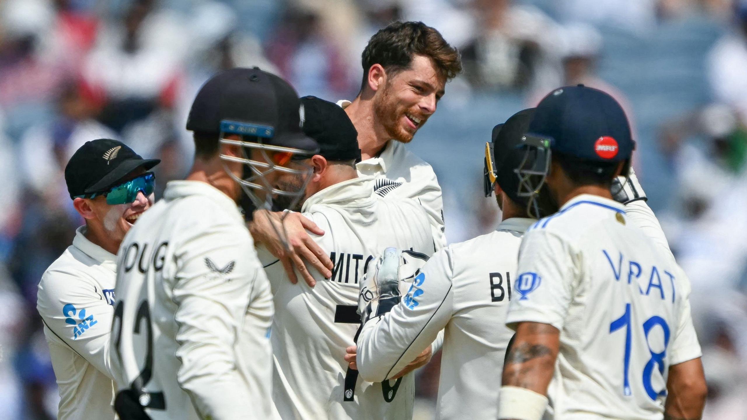 New Zealand players celebrate a wicket in the second Test against India in Pune