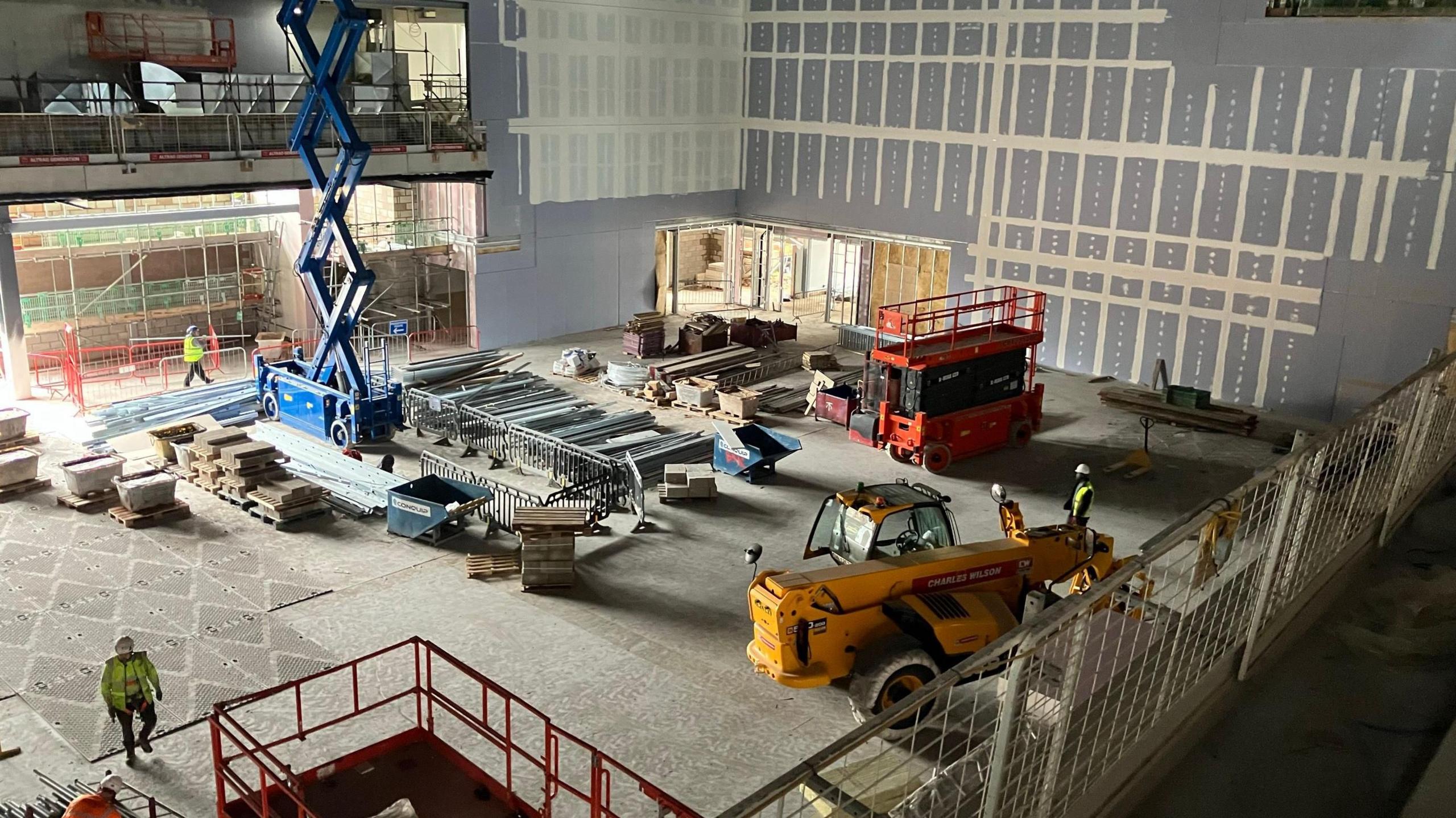 A large room inside the arena at Becketwell, full of construction equipment