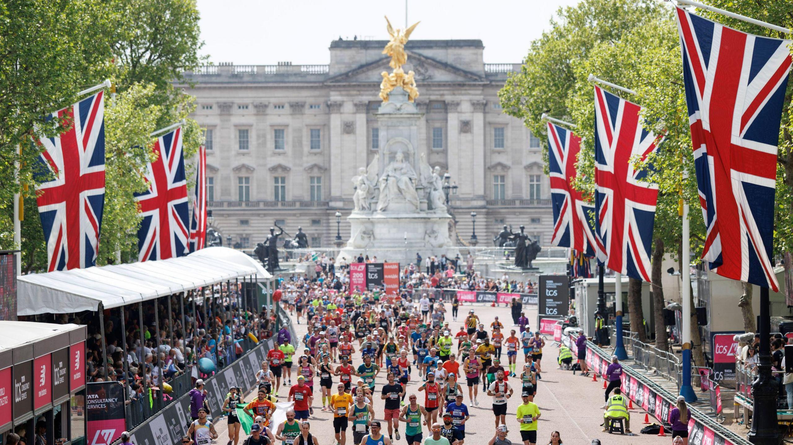 Buckingham Palace in the background with marathon runners in the foreground