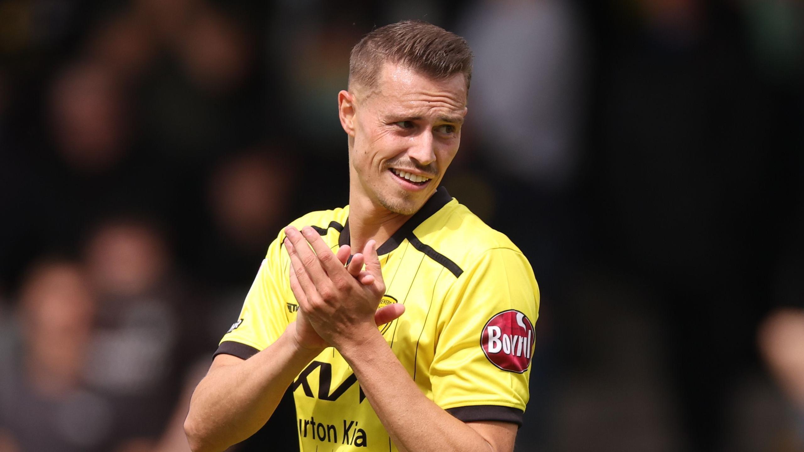 Billy Bodin claps his hands while on the pitch