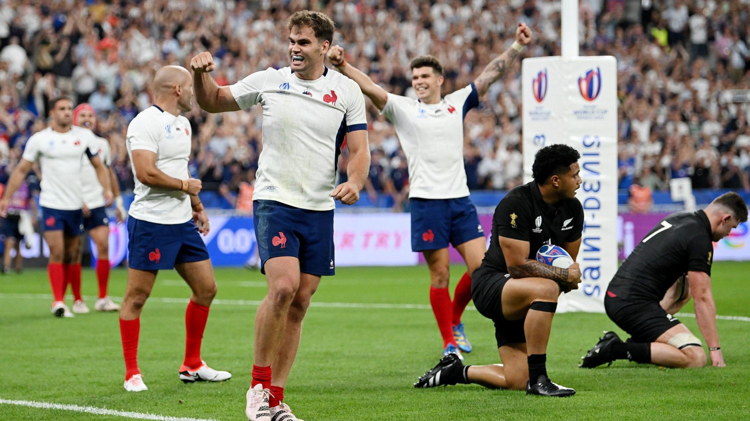 Damian Penaud celebrates in front of New Zealand players