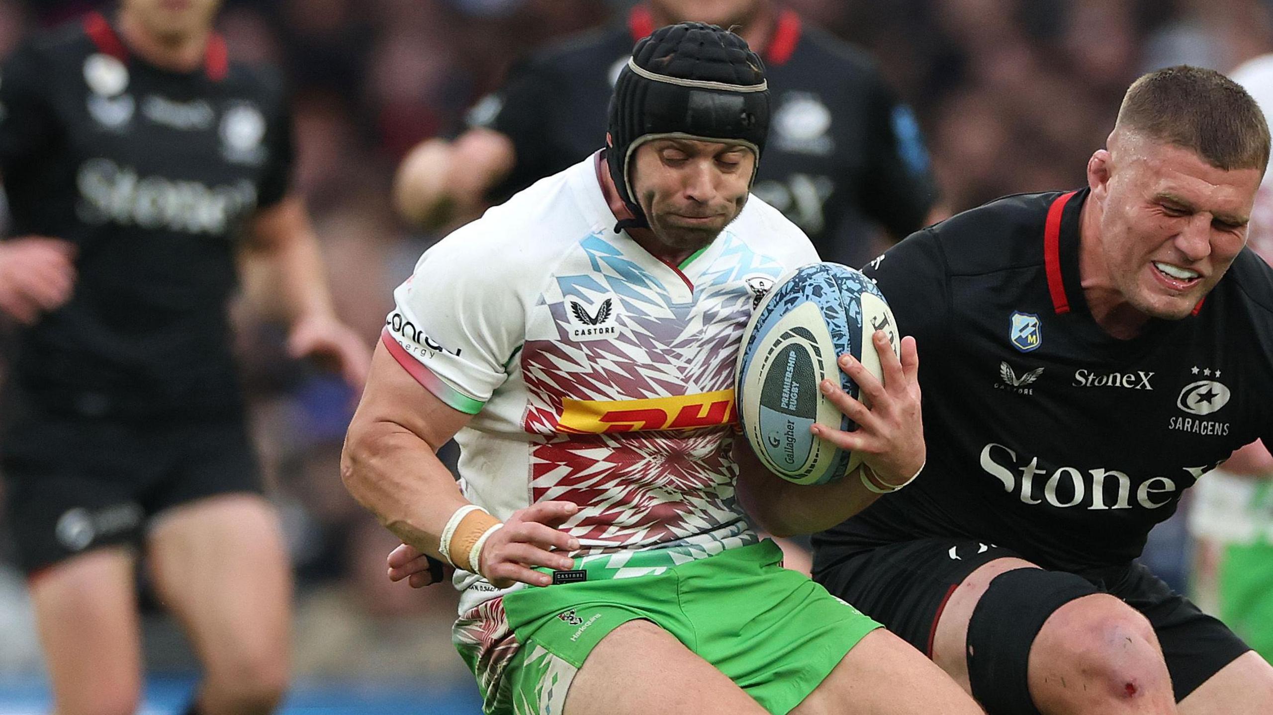 Leigh Halfpenny holds on to the ball under pressure from an opponent