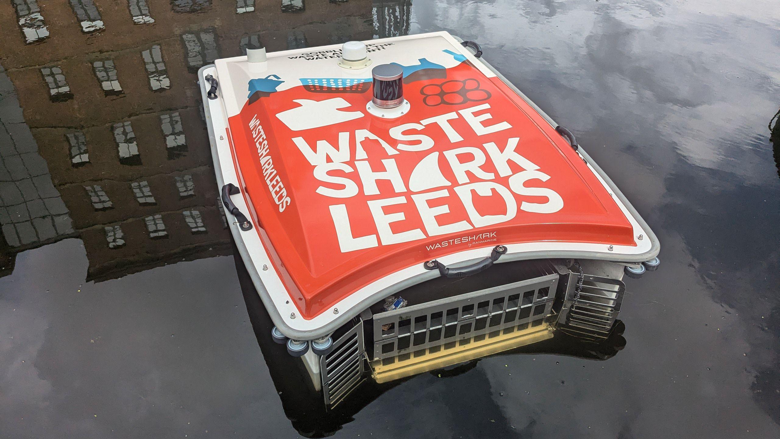 Robotic drone on the Leeds canal with reflection of buildings in the water