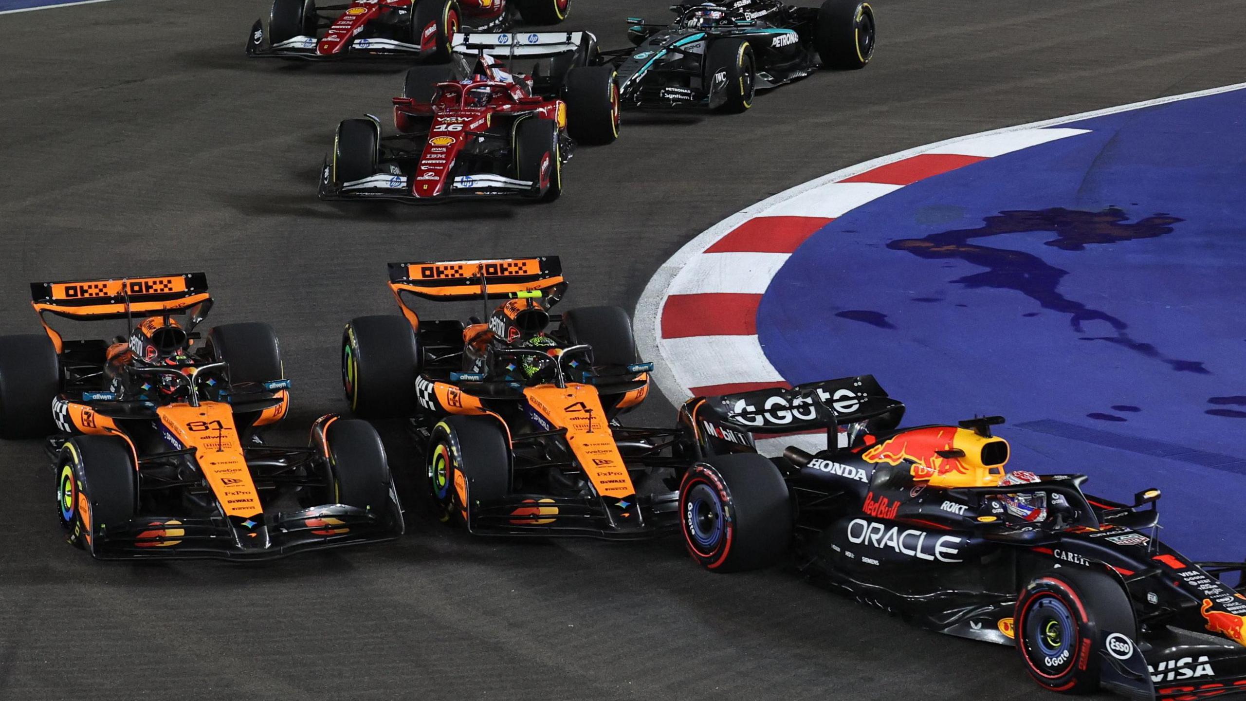 Lando Norris and Oscar Piastri alongside each other on lap one of the Singapore Grand Prix 