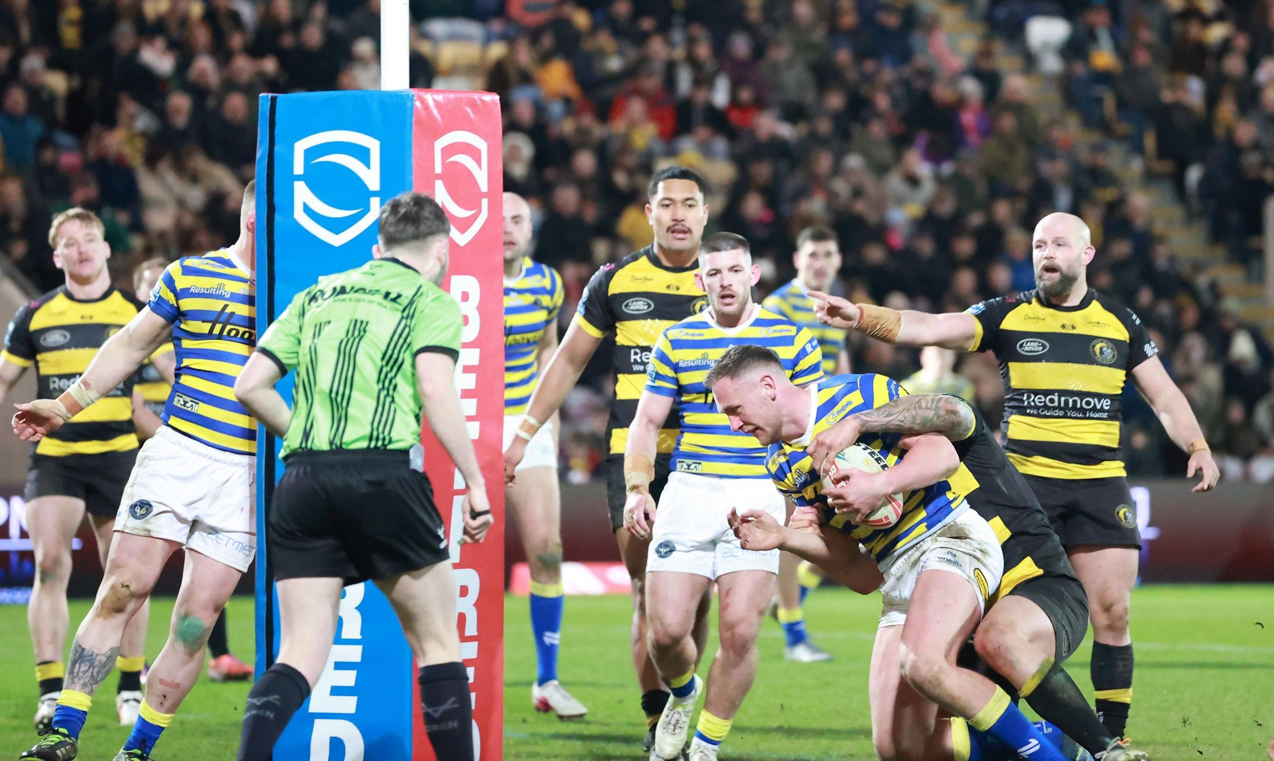 Warrington's Ben Currie (third right) goes over the line despite an attempted tackle by a York Knights player