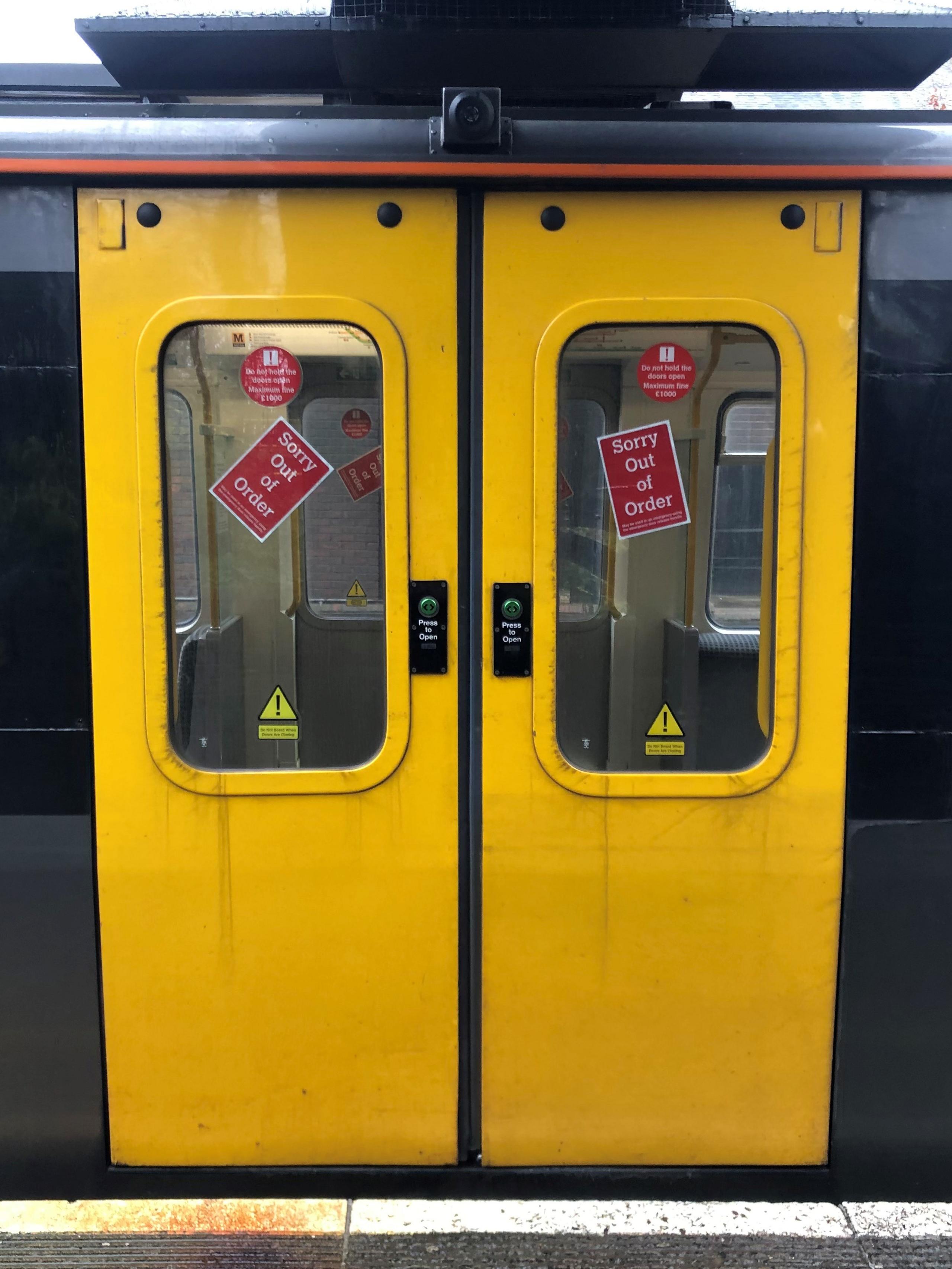 A Metro with out of order signs on its door