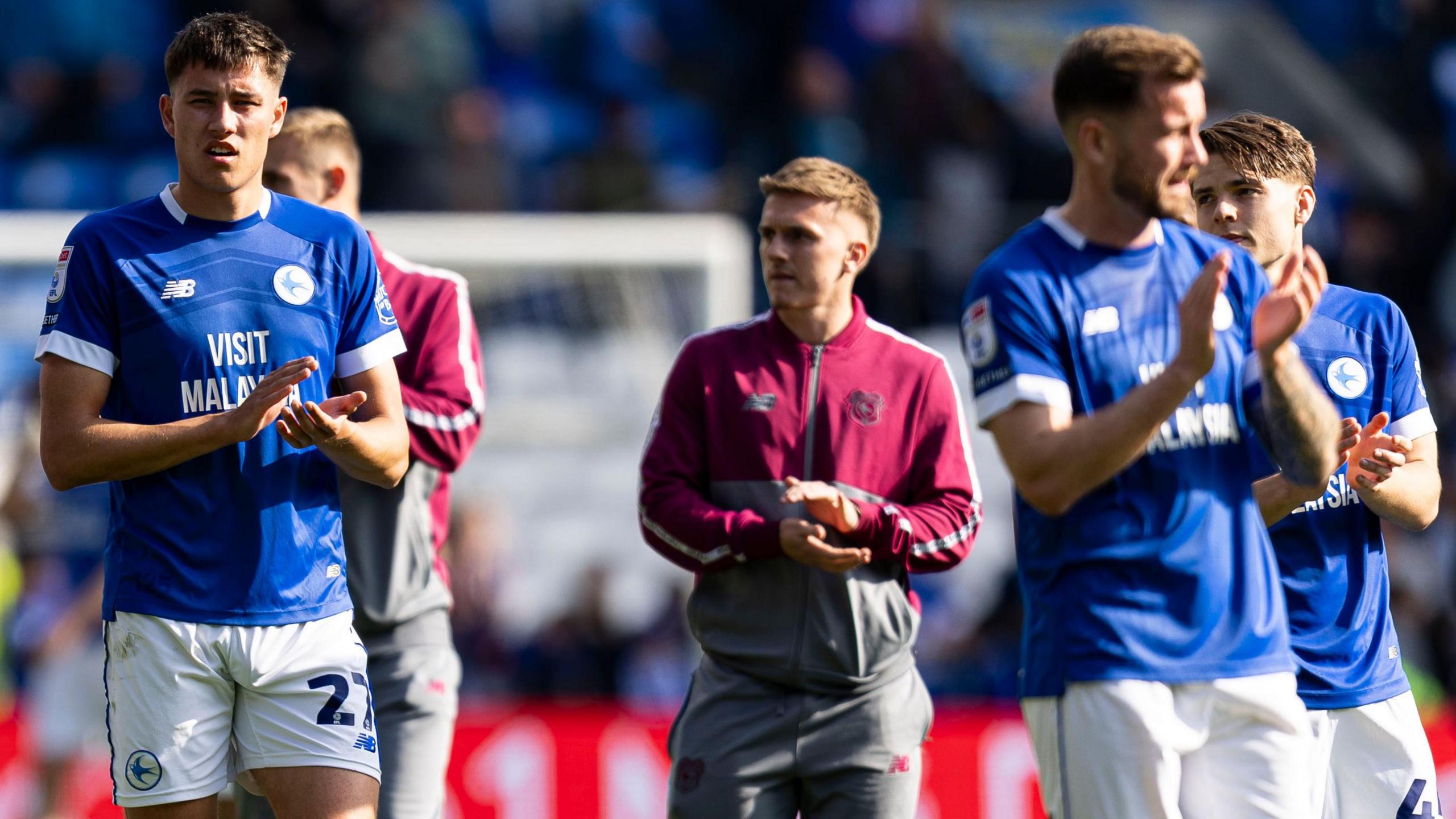 Cardiff players applaud their fans after relegation