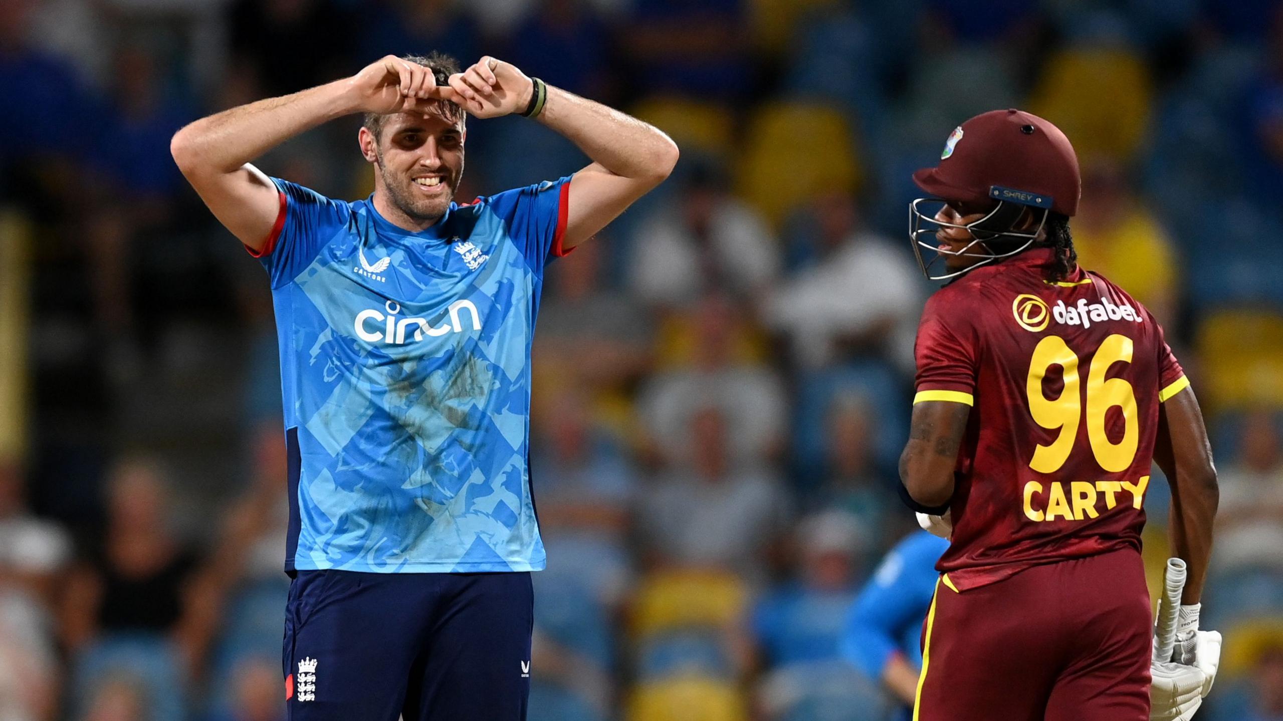 Jamie Overton of England reacts after bowling.