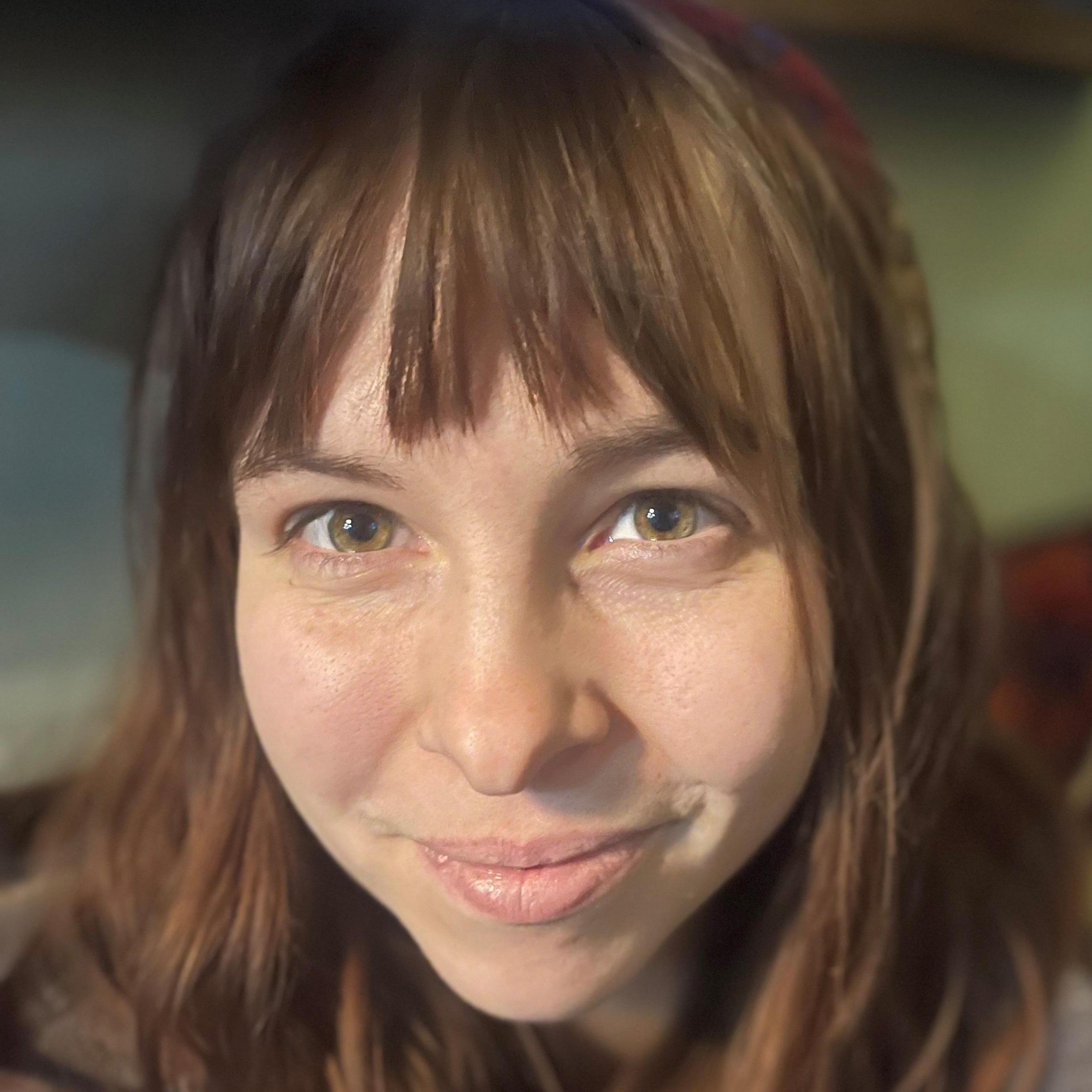  A woman looks into the camera from inside a houseboat