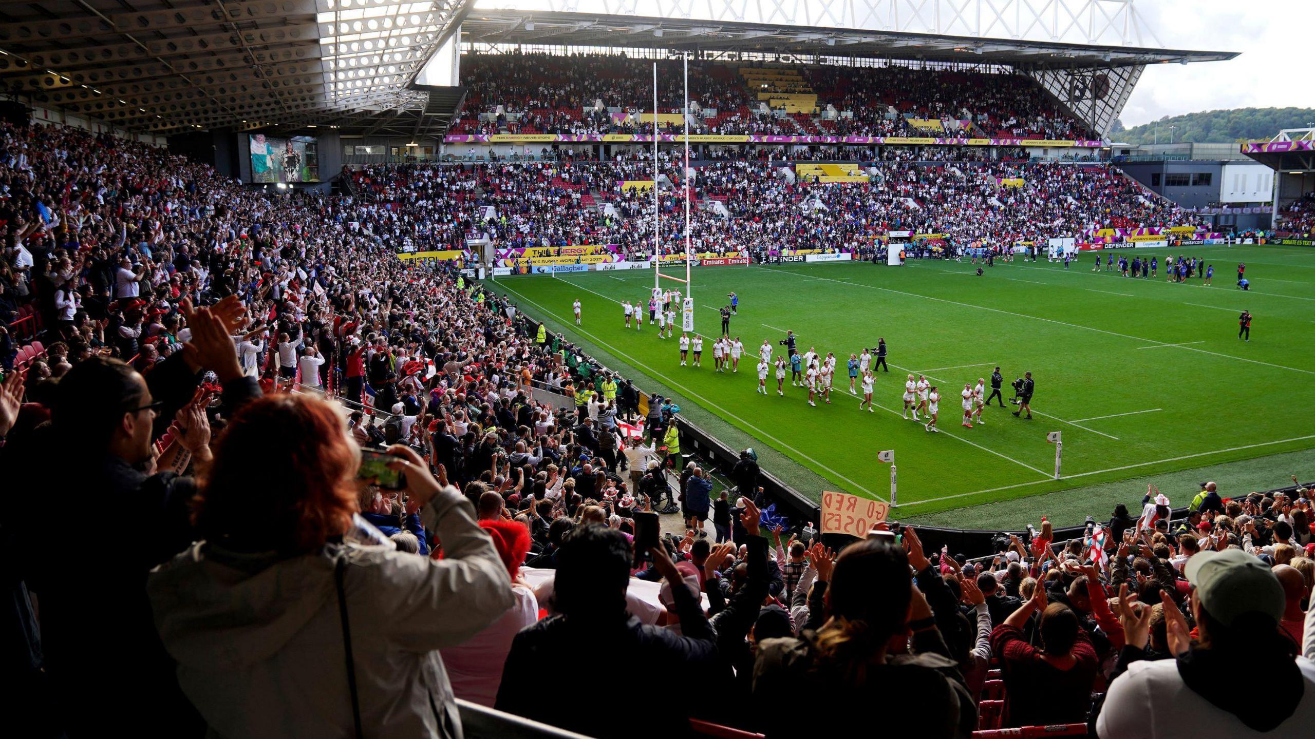 A view from the stands at Ashton Gate at the end of the England v France rugby World Cup semi-final. The England players are doing a lap of the pitch, and the people in the stands are applauding them